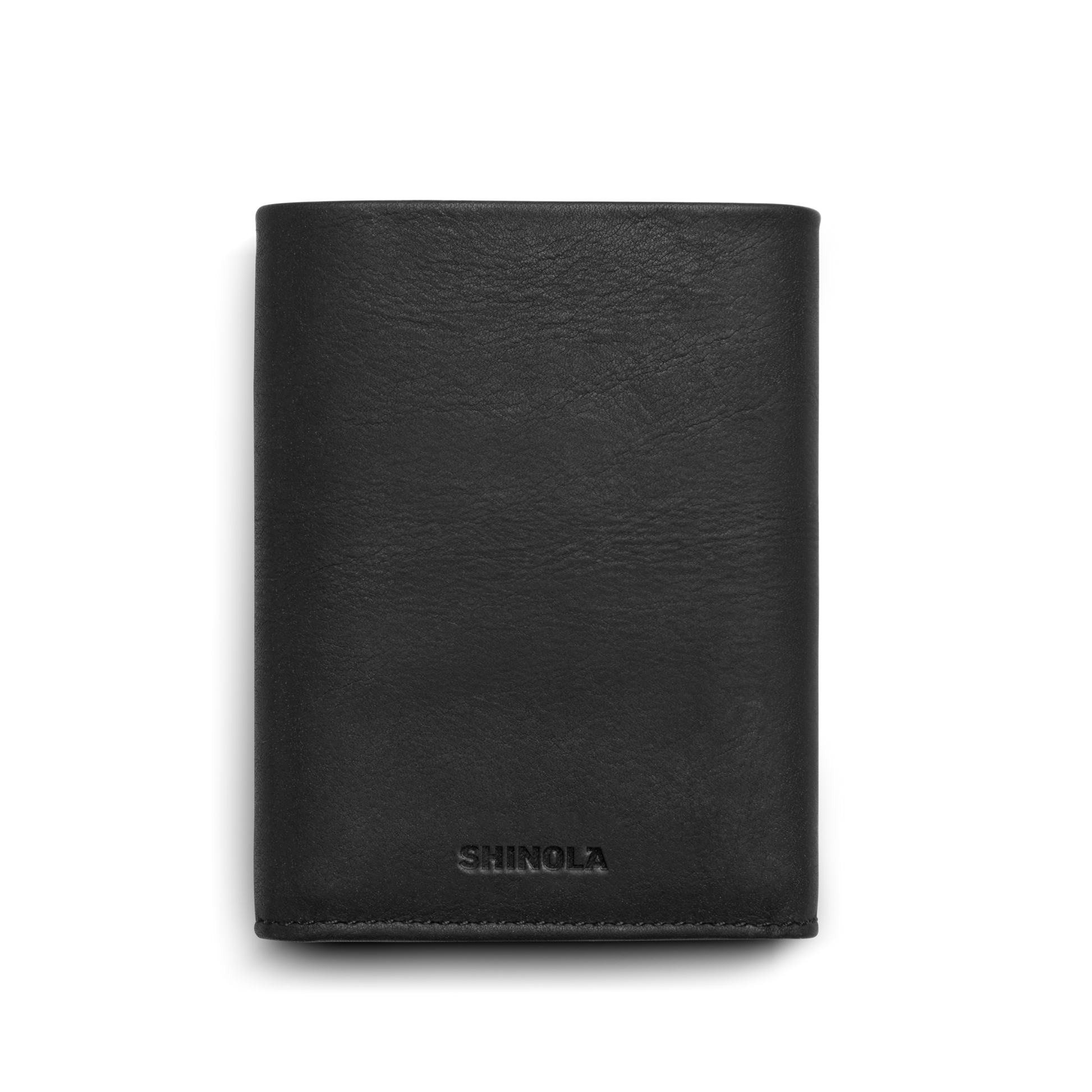 A Shinola Trifold Wallet - Black, crafted from smooth leather and embossed with "SHINOLA" near the bottom, is shown folded closed against a plain white background.