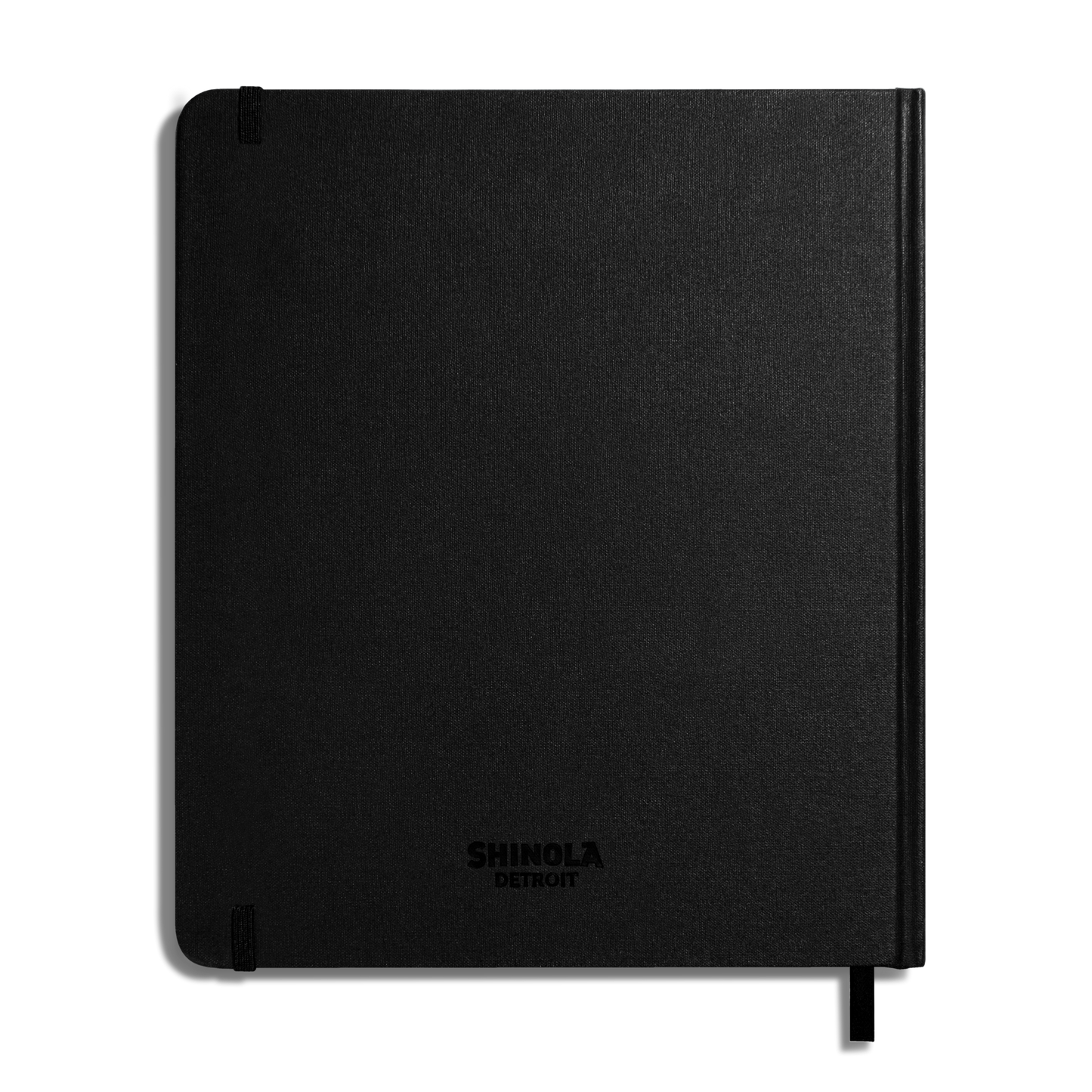 The Shinola Large Hard Plain Sketchbook - Black features durable hard linen covers, 100 lb weight pages, SHINOLA DETROIT embossed on the front, two corner elastic bands, and a ribbon bookmark.