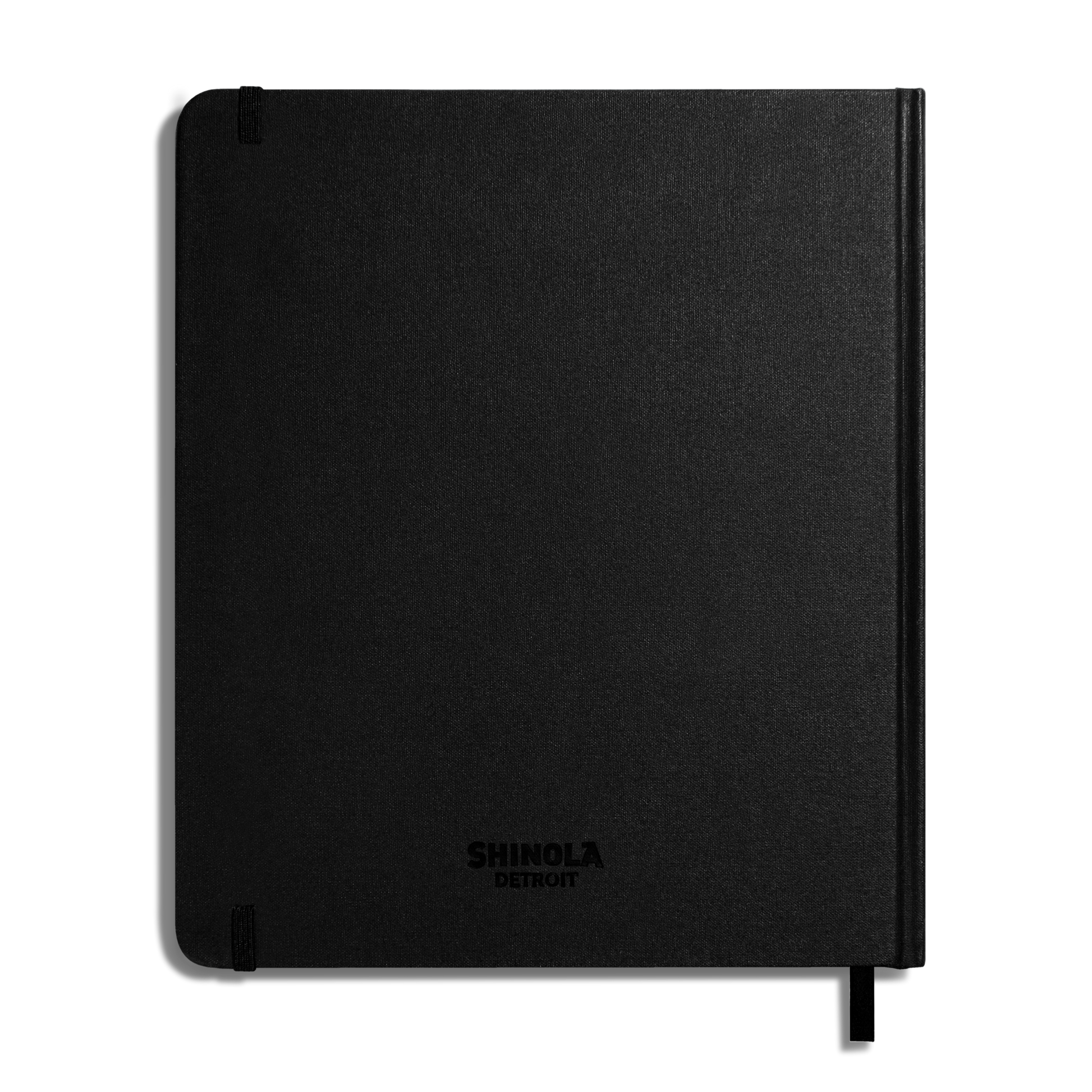 The Shinola Large Hard Plain Sketchbook - Black features durable hard linen covers, 100 lb weight pages, SHINOLA DETROIT embossed on the front, two corner elastic bands, and a ribbon bookmark.