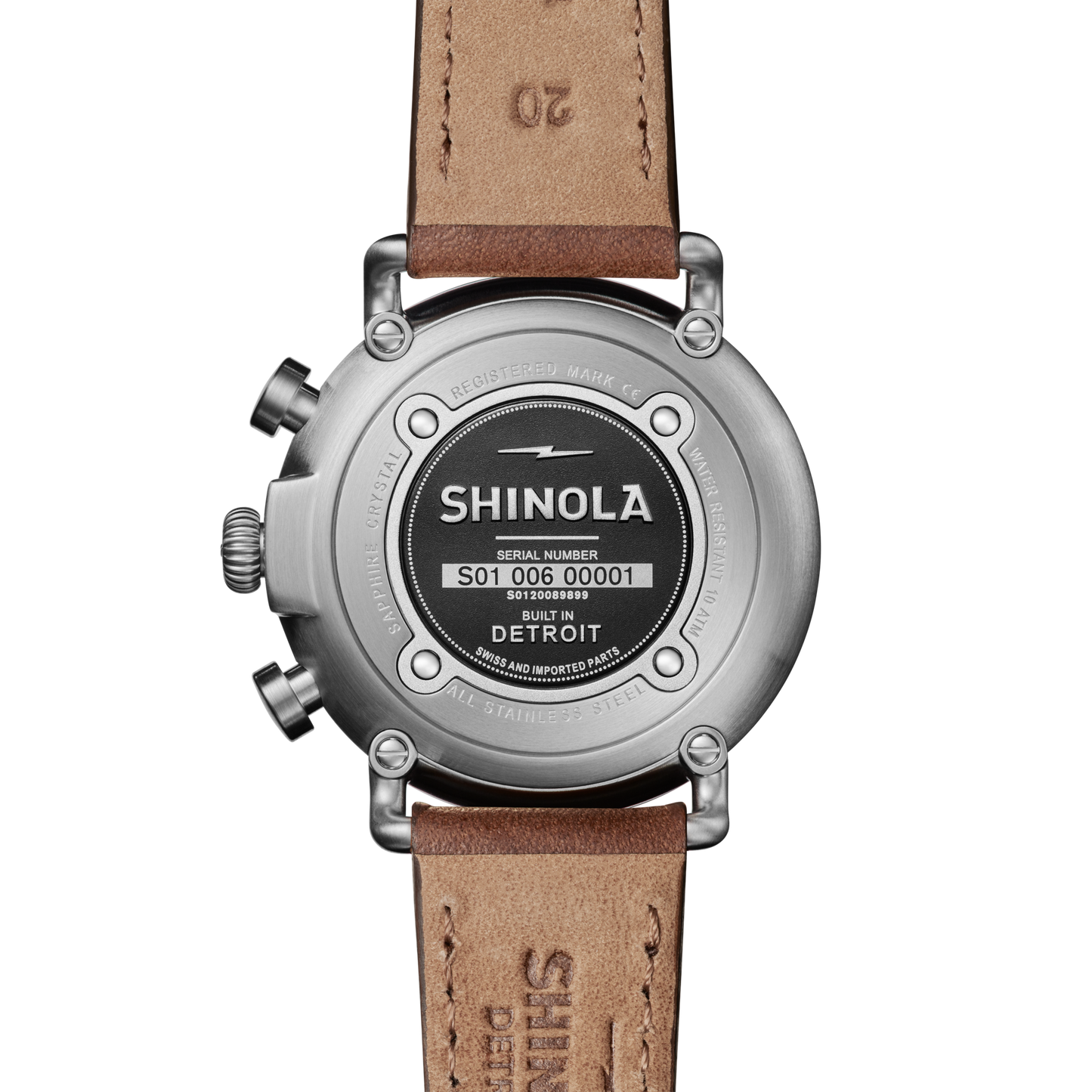 The back of a Shinola Runwell Chronograph Watch - Black features an engraved stainless steel case back with "Shinola," a serial number, "Built in Detroit," and the brand name stamped on the leather strap.