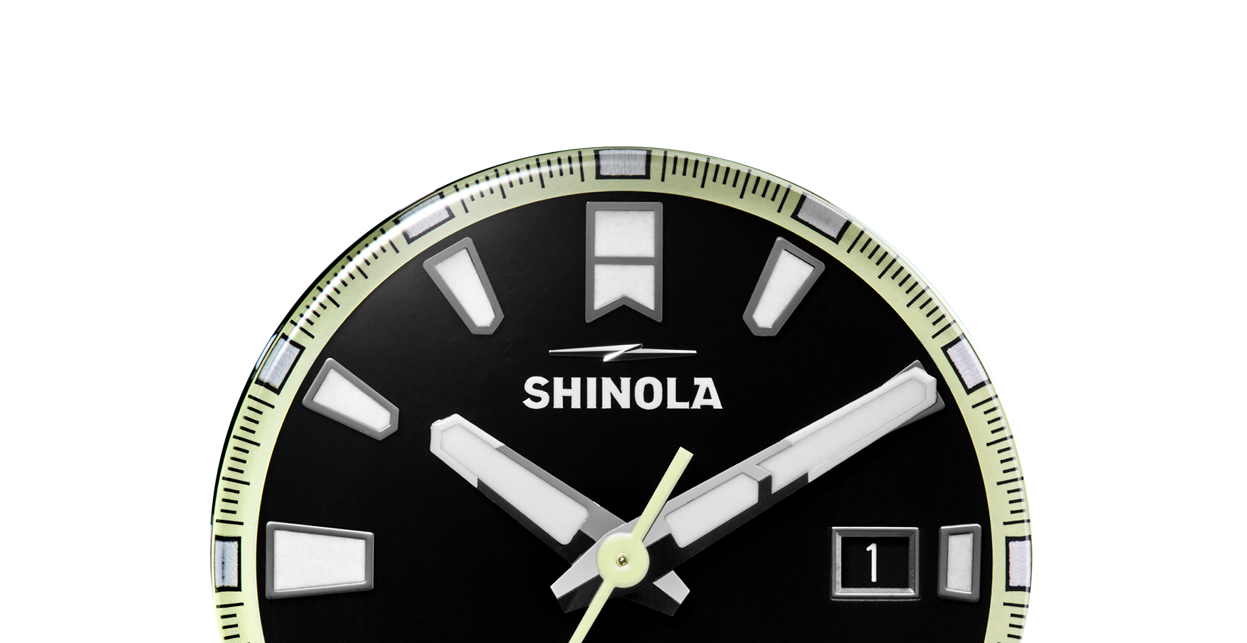 Close-up of the top half of a black Shinola Forged Carbon Monster Watch face with bold white hour markers, logo, and date window at 3 o’clock. Minute and hour hands show 4:02. Features a durable forged carbon case.