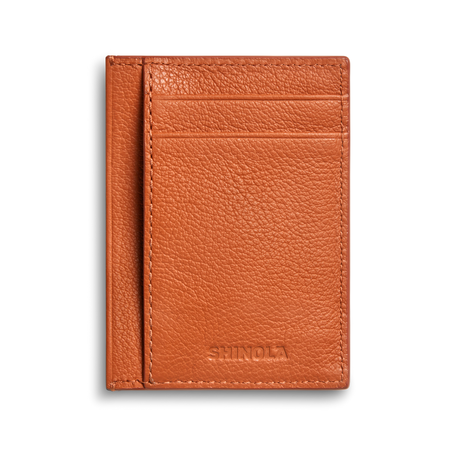 The Canfield ID Card Holder by Shinola is a slim, rust-colored pebbled leather wallet with two card slots and the brand's name embossed at the bottom, perfect for stylishly carrying your ID.