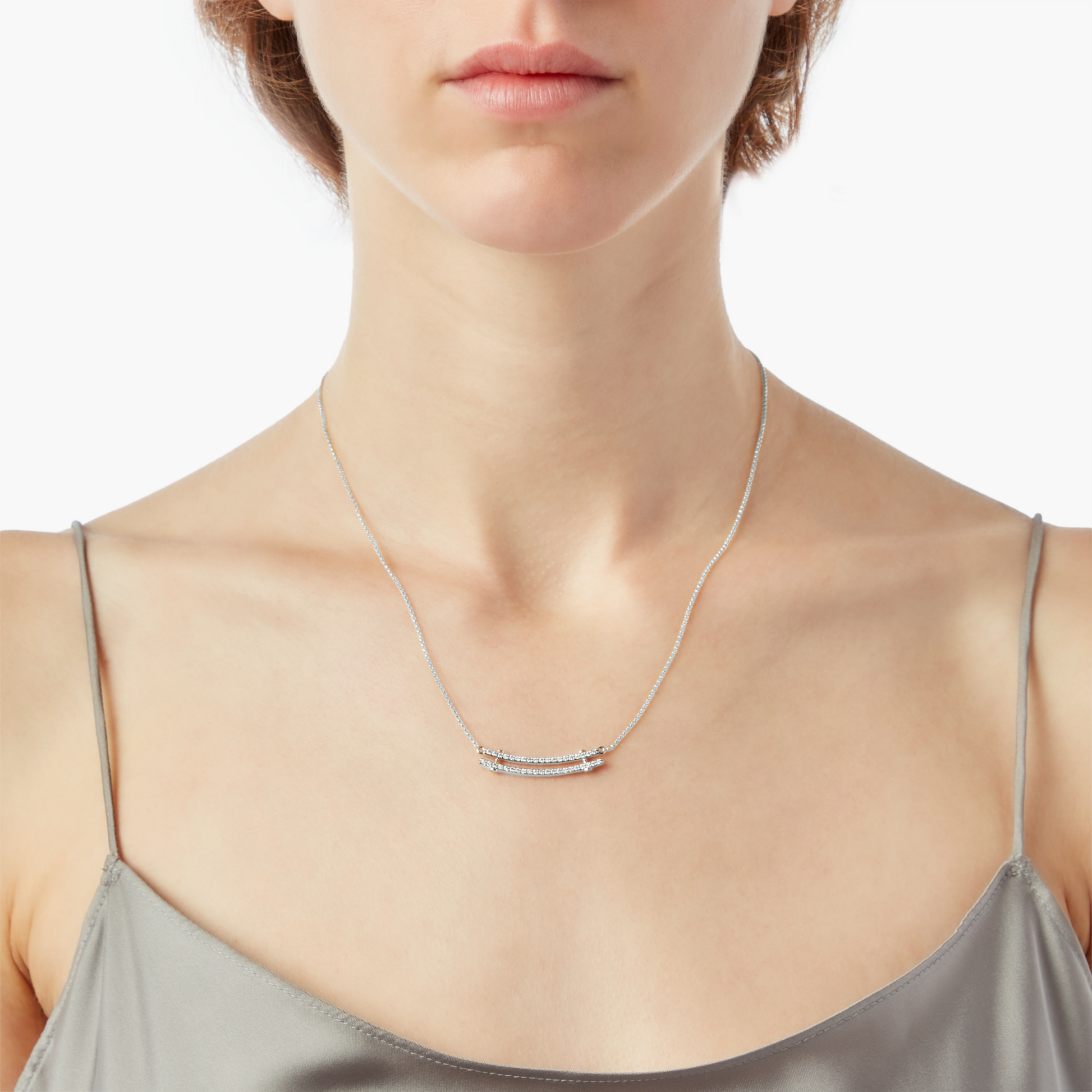 A woman in a light gray spaghetti strap top wears the Shinola Diamond Pave Rivet Double Row Necklace in white gold, shown from the shoulders up against a white background.
