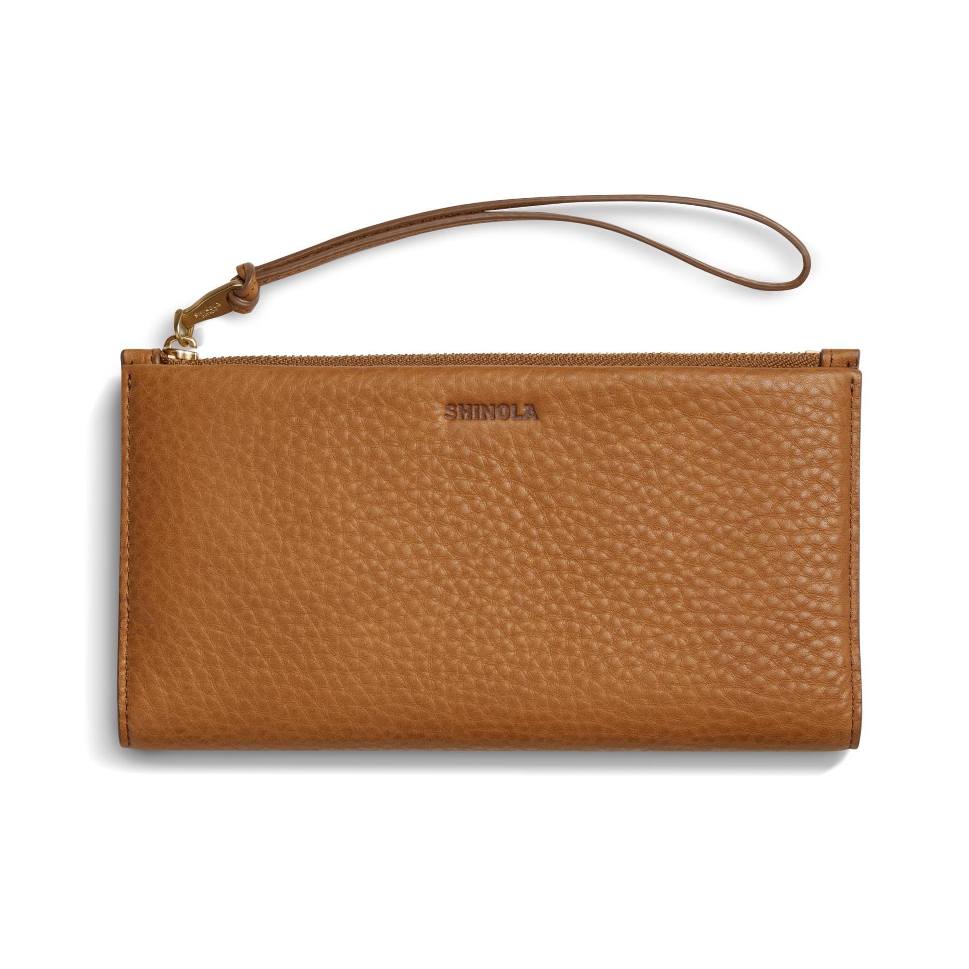 The Shinola Wristlet Wallet - Tan features textured natural grain leather, a wrist strap, zipper closure, and an embossed logo on the front, displayed against a white background.