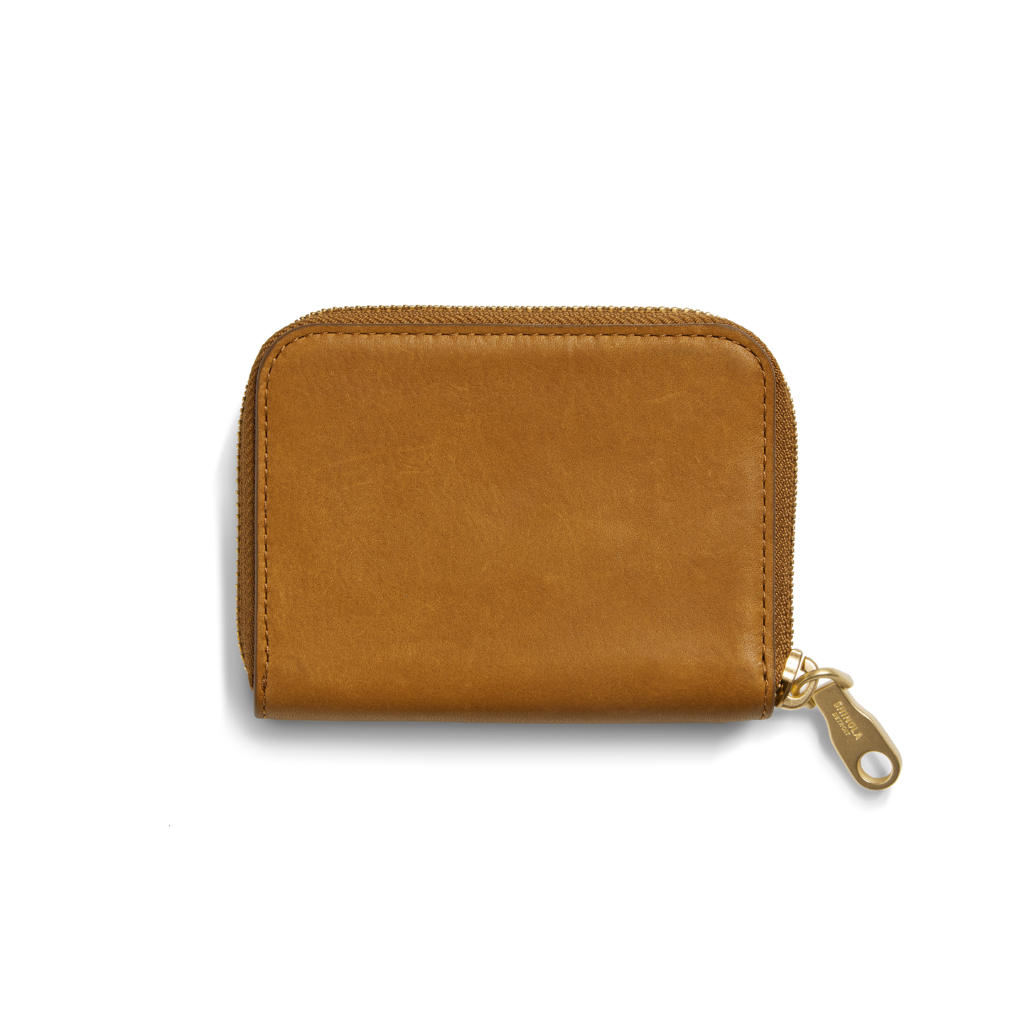 The Shinola Pocket Small Zip Around Wallet in tan natural leather features a gold zipper and is shown closed against a plain white background.