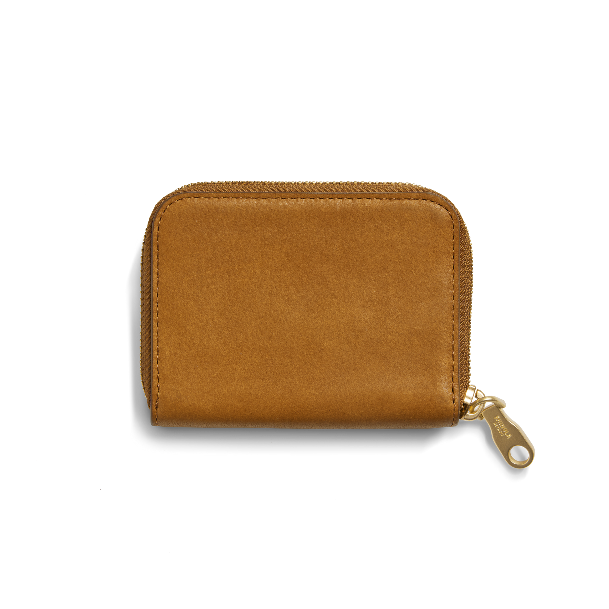 The Shinola Pocket Small Zip Around Wallet in tan natural leather features a gold zipper and is shown closed against a plain white background.
