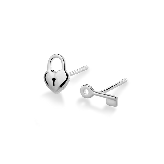 The Shinola Petite Heart and Lock Earrings are crafted from .925 sterling silver, featuring one heart-shaped padlock and one key stud, shown against a white background.