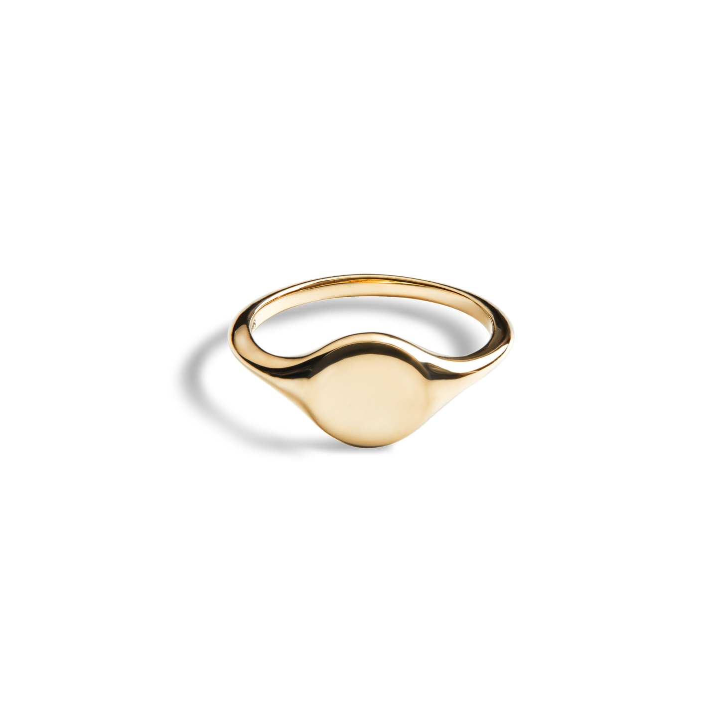 The Shinola Petite Round Signet Ring - Yellow Gold features a smooth, oval face in 14k gold, offering timeless elegance. Photographed on a white background.