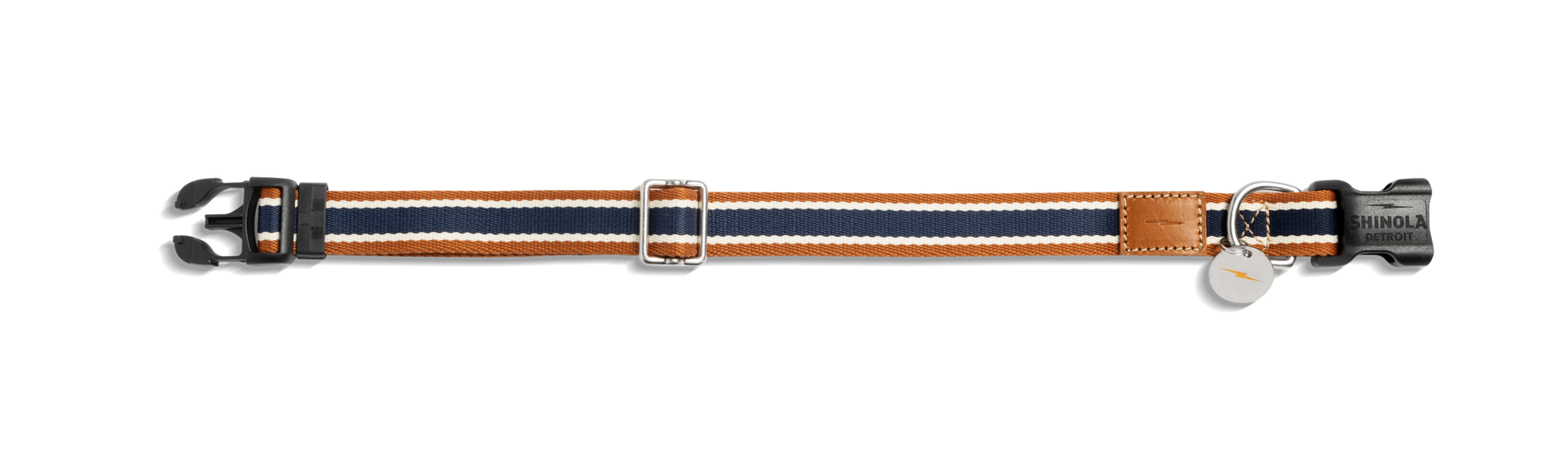 The Shinola Nylon Dog Collar - Brand Stripe features navy, white, and orange bands, a black plastic buckle, adjustable metal slider, leather patch accent, and two metal tags attached to a ring.