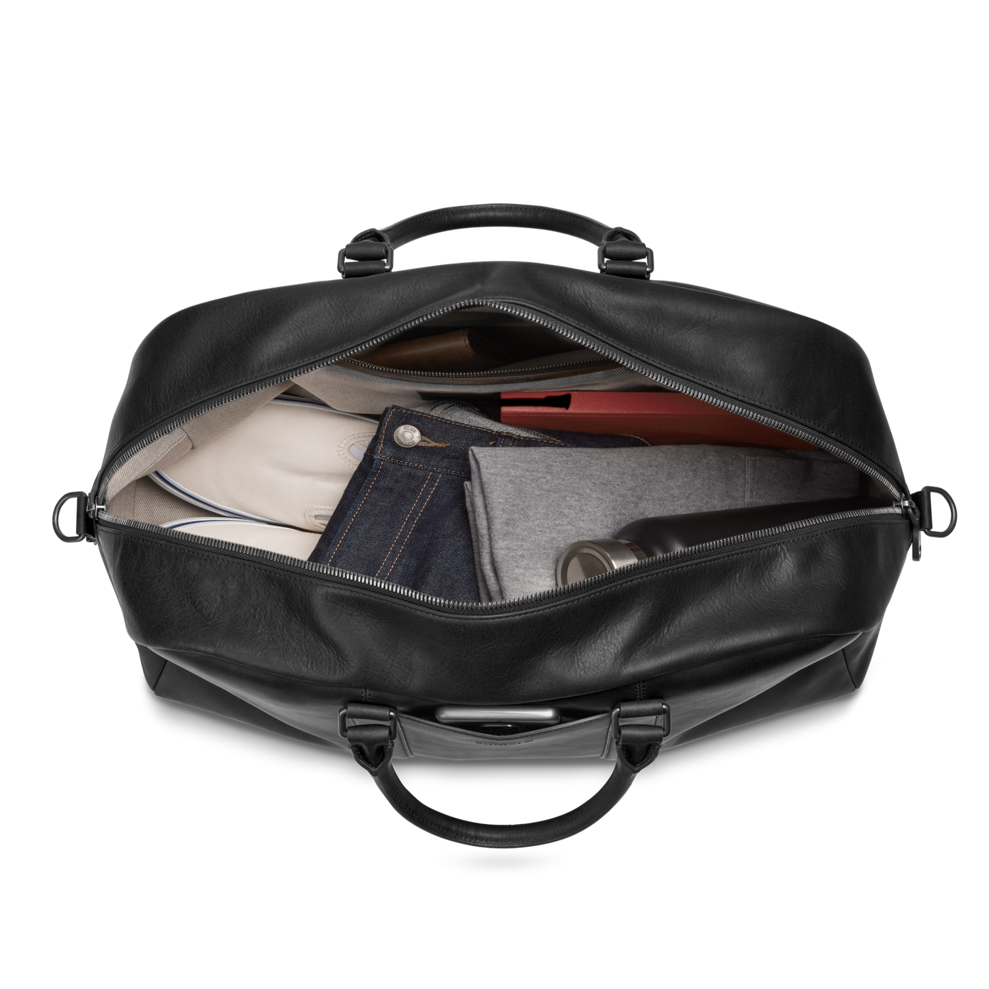 The Shinola Runwell Duffle Bag - Black, crafted from premium Navigator leather, is seen unzipped to reveal neatly packed clothes and a water bottle inside this stylish carry-on.