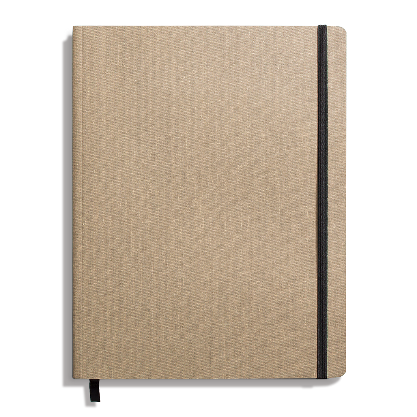 The Shinola Large Soft Ruled Journal in Oat features a textured tan linen cover, black elastic closure, ribbon bookmark, and acid-free pages. The closed journal is shown on a white background.