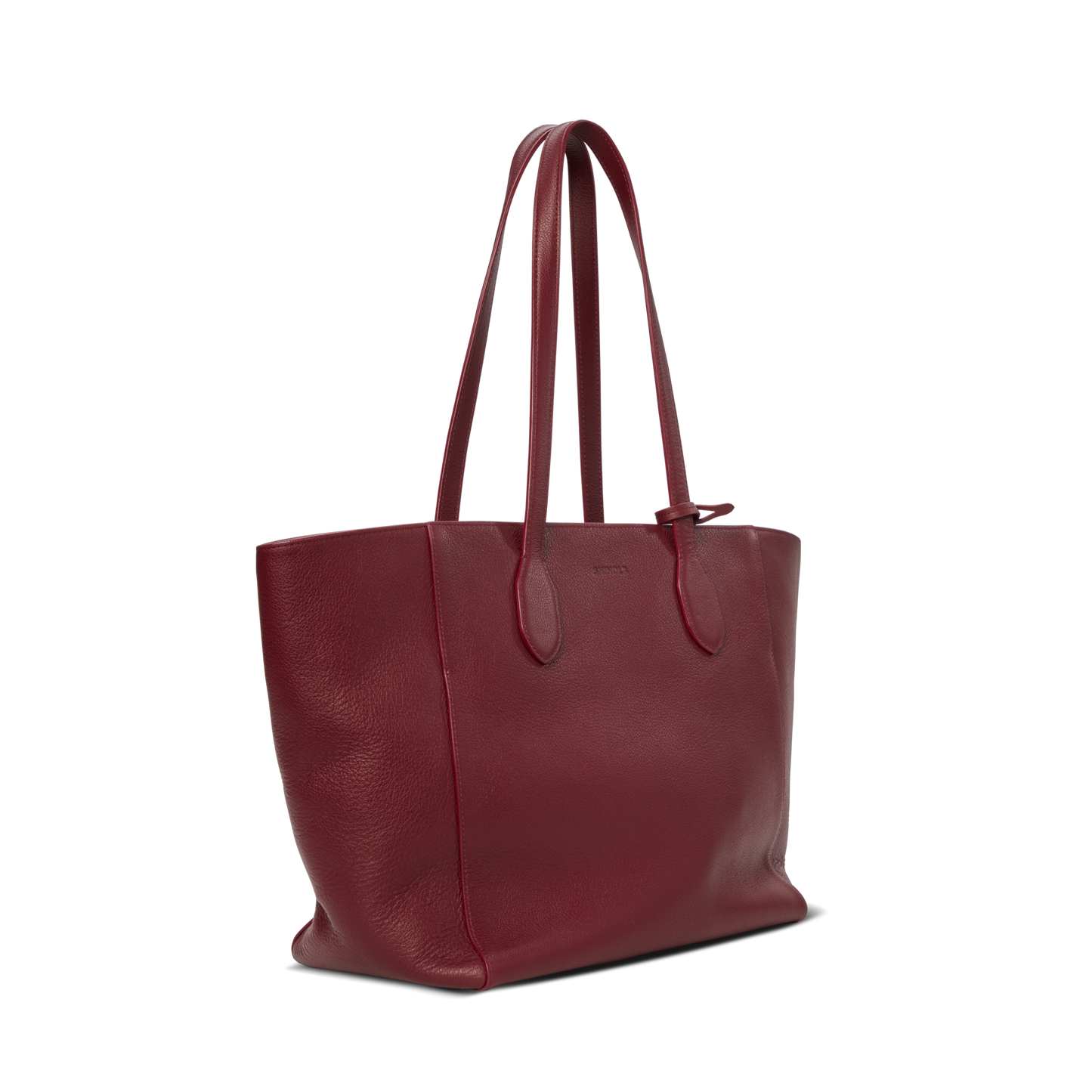 The Shinola Runabout Tote Bag - Ruby is a large, lightweight burgundy pebbled leather bag with two long shoulder straps, displayed at a three-quarter angle on a plain white background.