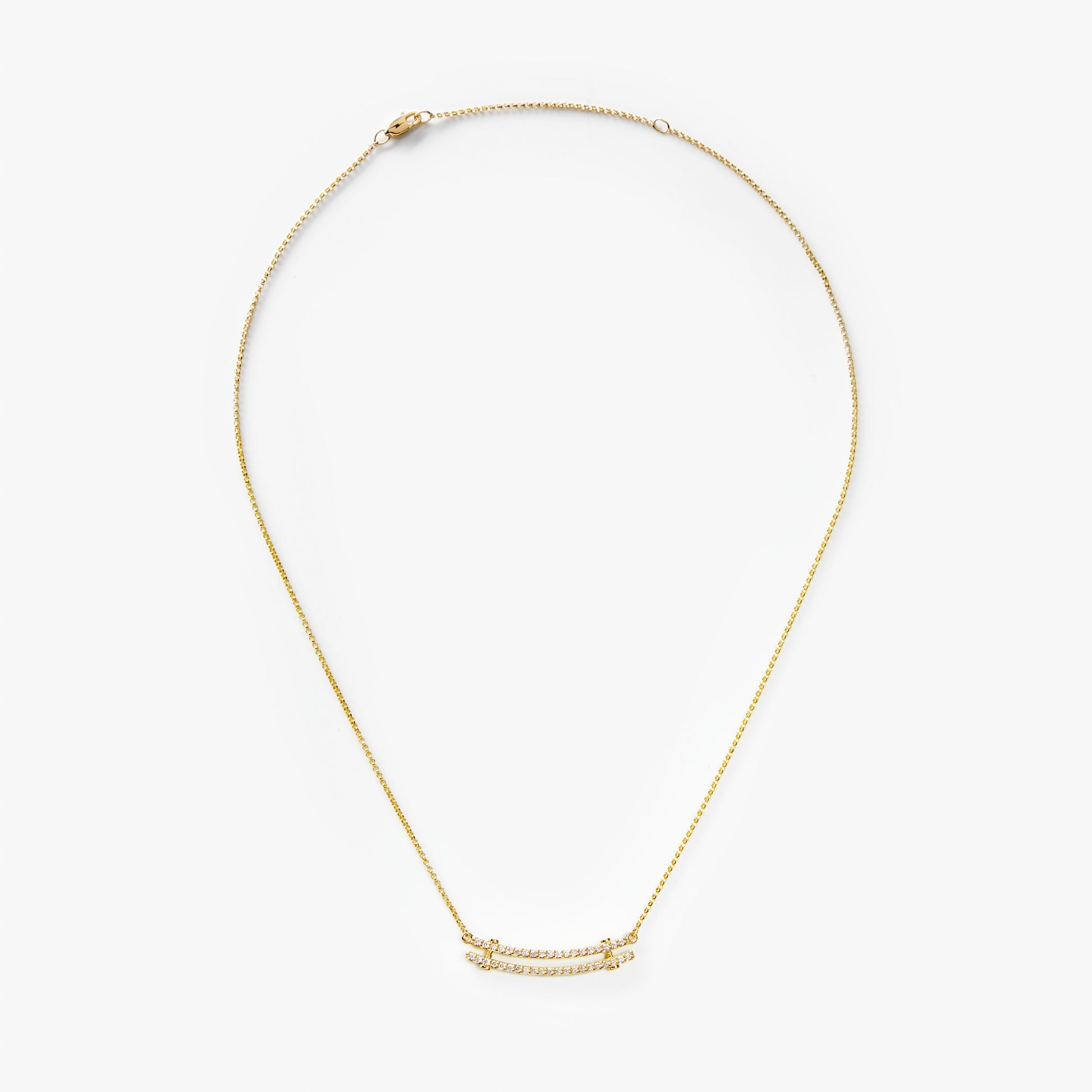 The Shinola Diamond Pave Rivet Double Row Necklace in yellow gold features two curved, crystal-encrusted bars on a fine double chain, elegantly displayed against a white background.