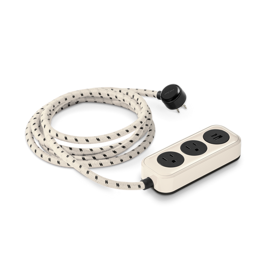 The Shinola 2 Port Power Supply - Cream features two black outlets, a quick-charge USB-A & USB-C port, a long braided extension cord, and a matching black plug.