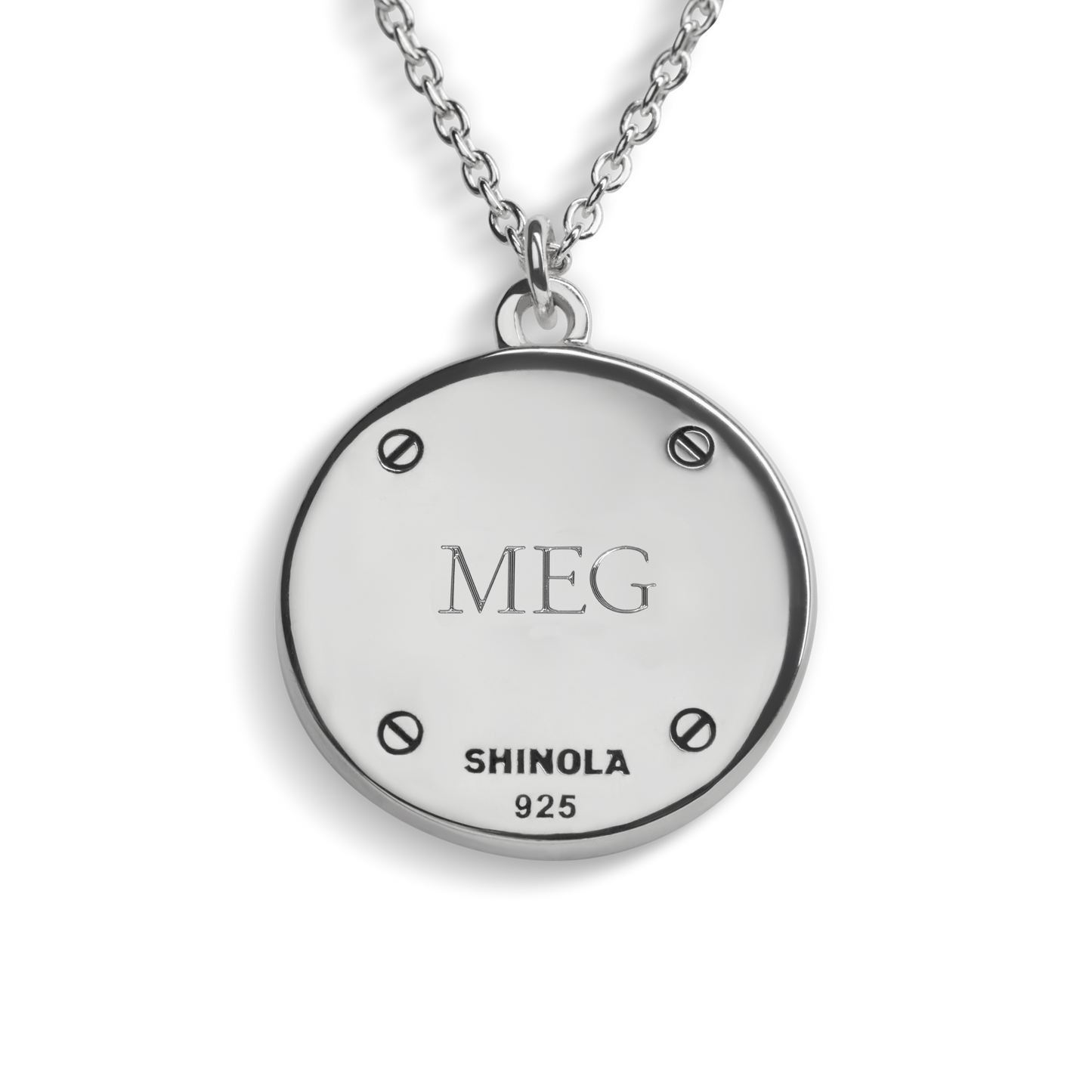 The Shinola Heirloom Turquoise Pendant Necklace features a round sterling silver pendant engraved with MEG, SHINOLA 925, and four screw-like details on the edges—a personalized jewelry piece.