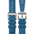 The 20mm Blue Rubber Watch Strap by Shinola is displayed from multiple angles, featuring a textured blue band, a silver buckle with a lightning bolt detail, and the Shinola brand name on the strap.