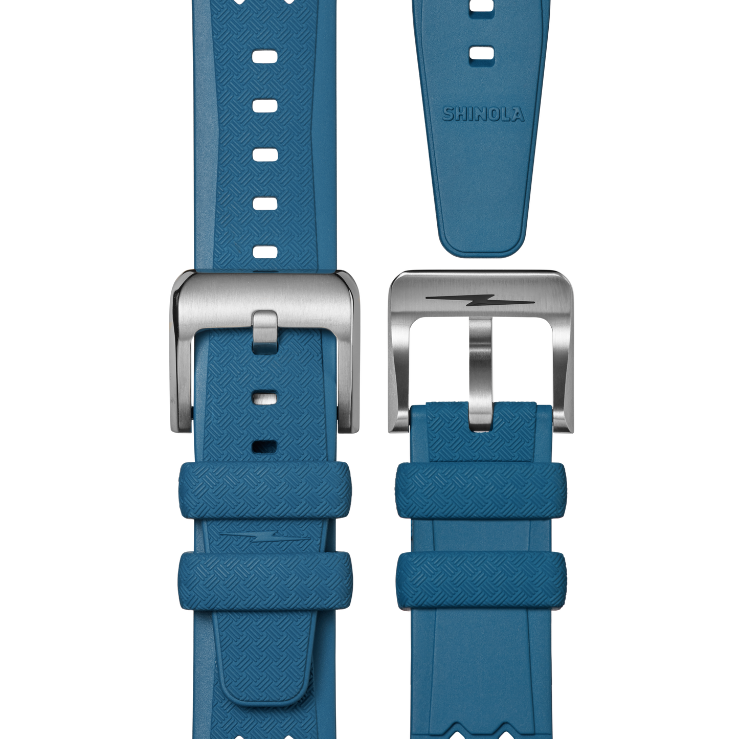 The 20mm Blue Rubber Watch Strap by Shinola is displayed from multiple angles, featuring a textured blue band, a silver buckle with a lightning bolt detail, and the Shinola brand name on the strap.