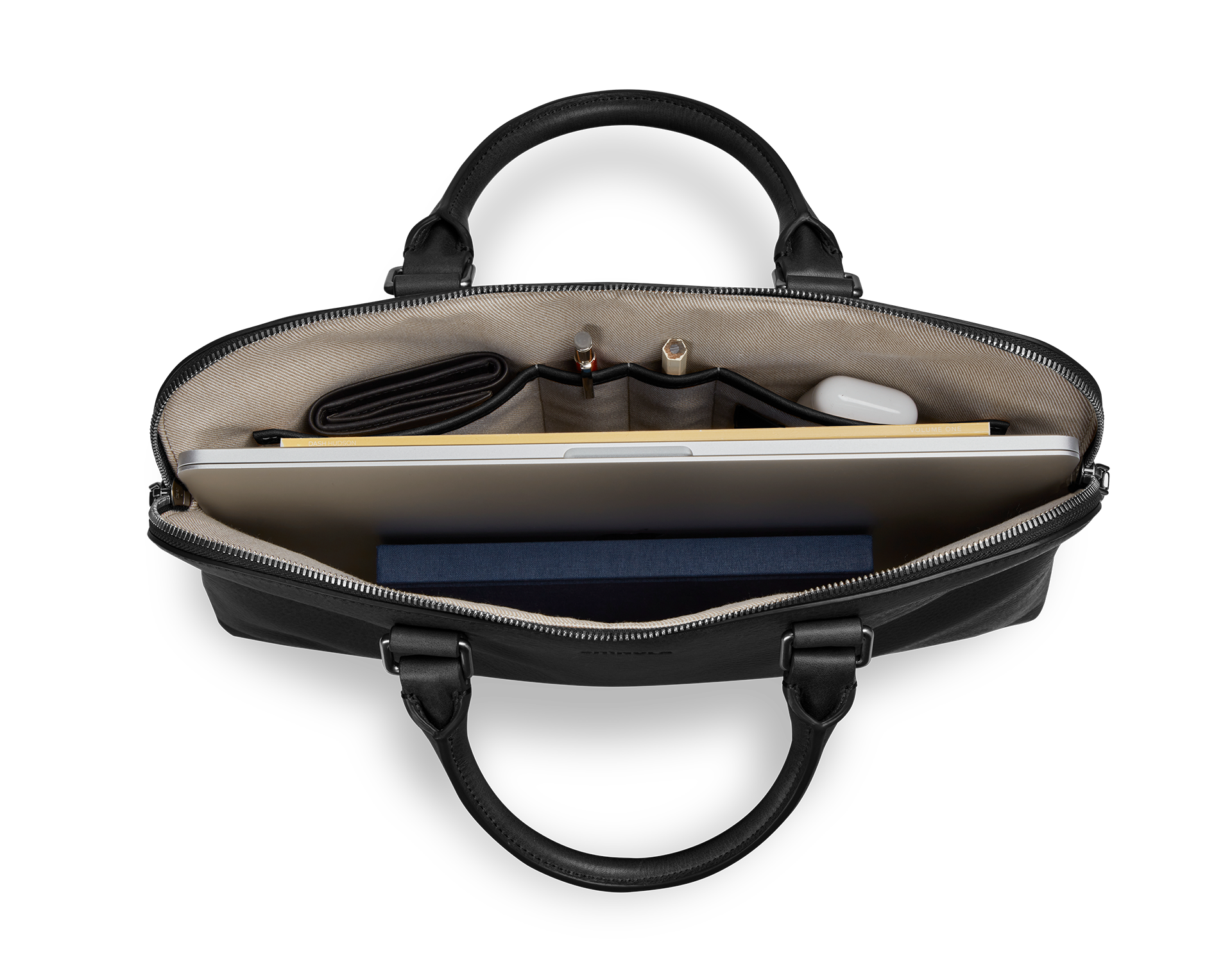 Top view of the Shinola Portfolio Briefcase - Black, open to show organized contents—laptop, notebook, wallet, pens, and a white wireless earbud case in beige-fabric-lined compartments.