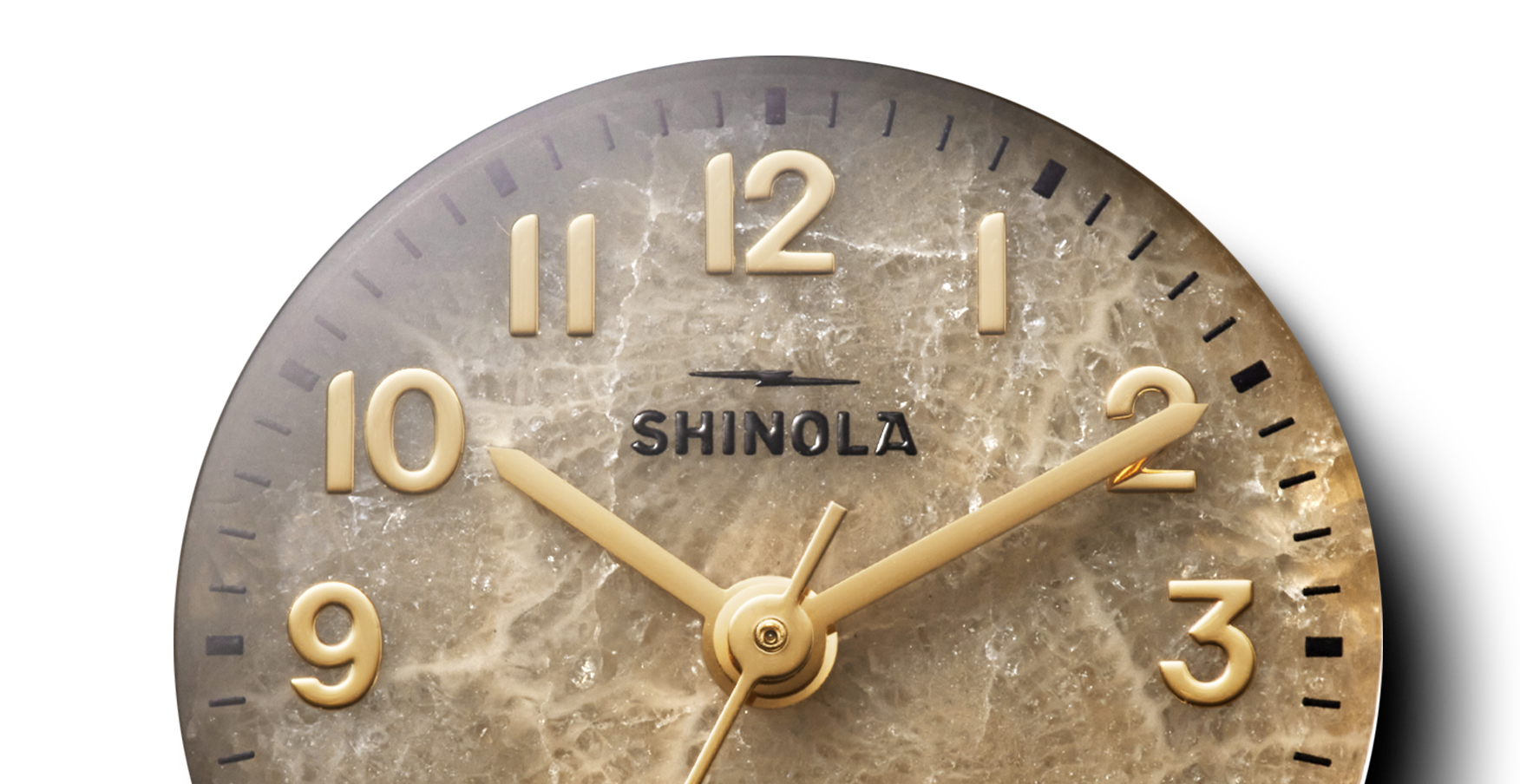Close-up of the Shinola Runabout Watch – Petoskey, featuring gold numerals and hands on a marbled Petoskey stone dial. The Detroit-assembled timepiece shows approximately 2:09.