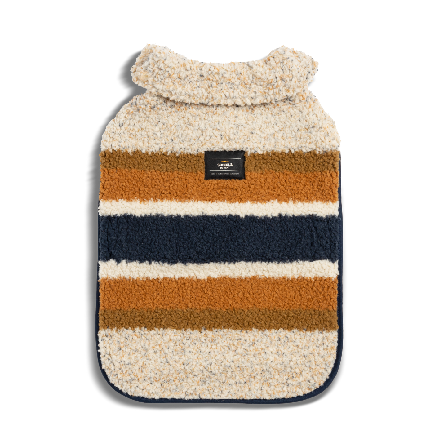 The Shinola Dog Coat - Brand Stripe Ombre features soft sherpa, cream, rust, brown, and navy blue stripes, a small black back label, and a thick folded collar for cozy comfort.