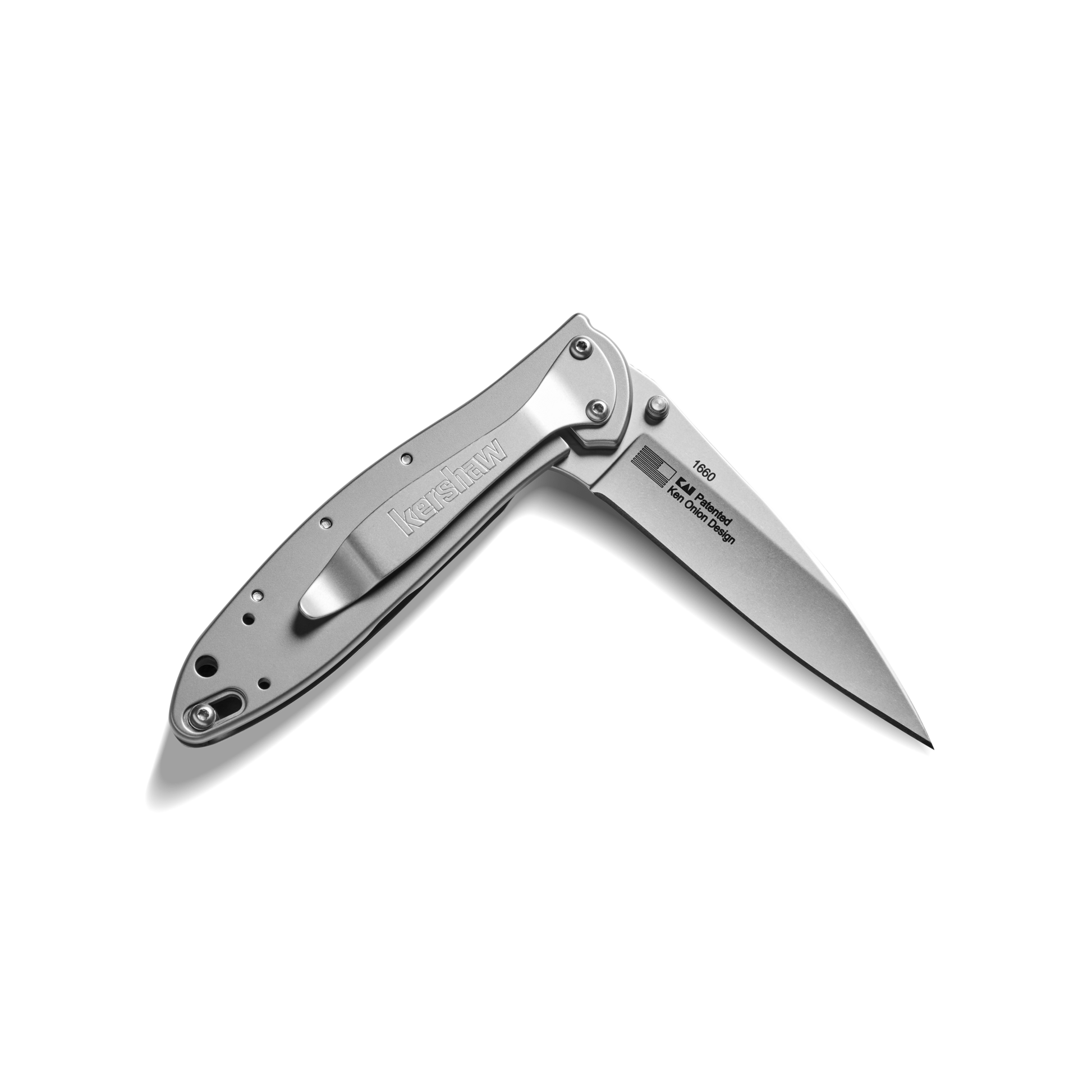 A Shinola + Kershaw Petoskey Stone Pocket Knife with a partially open, pointed blade and a sleek metal handle is shown against a plain white background.
