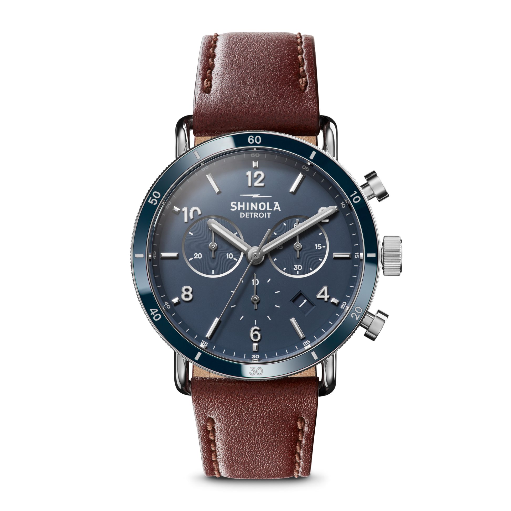 The Shinola Canfield Sport Chronograph Watch - Midnight Blue features a blue dial with silver hands and markings, three subdials, a chronograph function, and a brown leather strap. The watch face reads Shinola Detroit on a plain white background.