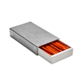 The Shinola Aluminum Matchbox Set features a rectangular, engravable case with a sliding drawer partially open to display neatly arranged orange-tipped matches inside.