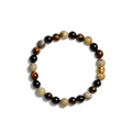 The Shinola 8mm Beaded Bracelet Multi Stone features alternating brown, black, and beige round stones with a gold cylindrical bead, all arranged in a circular pattern on a plain white background.