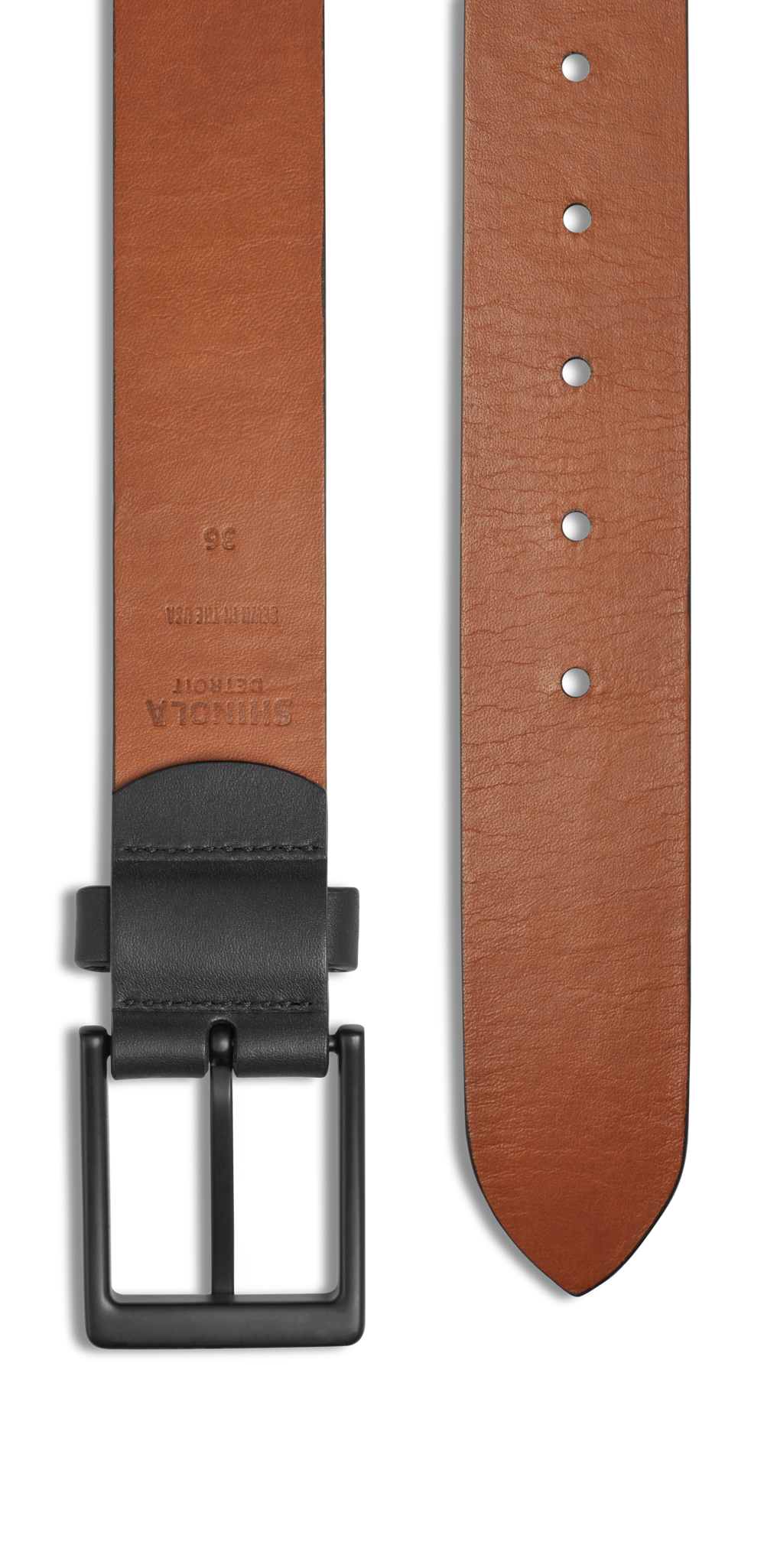 The Shinola 1 1/2" Lightning Bolt Keeper Belt in black features nappa leather, a black metal buckle, embossed branding, belt holes, and a subtle lightning bolt symbol on the leather. Shown both buckled and unbuckled.
