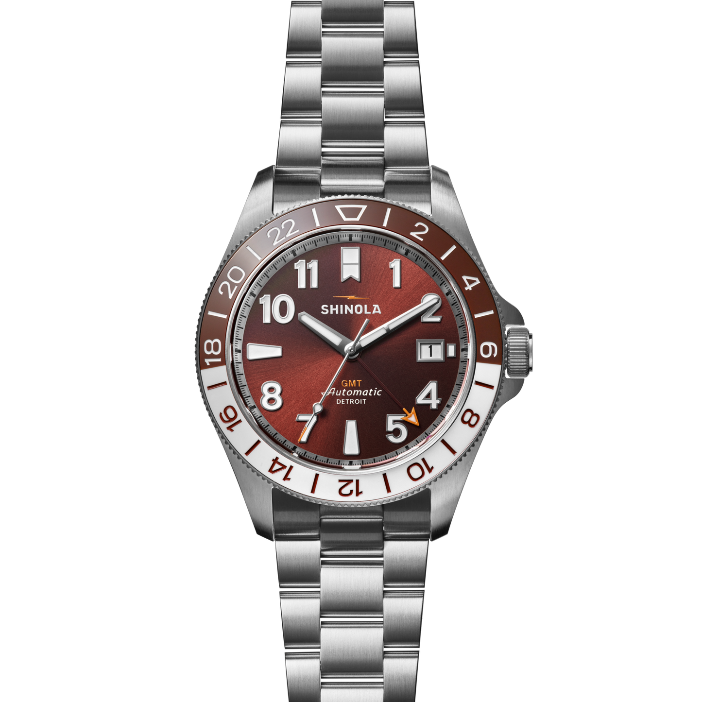 The Shinola Monster GMT Automatic Watch - Whiskey features a stainless steel case, red-brown dial with white markers, two-tone brown/silver 24-hour bezel, date at 4 o'clock, automatic movement, and a metal link bracelet.