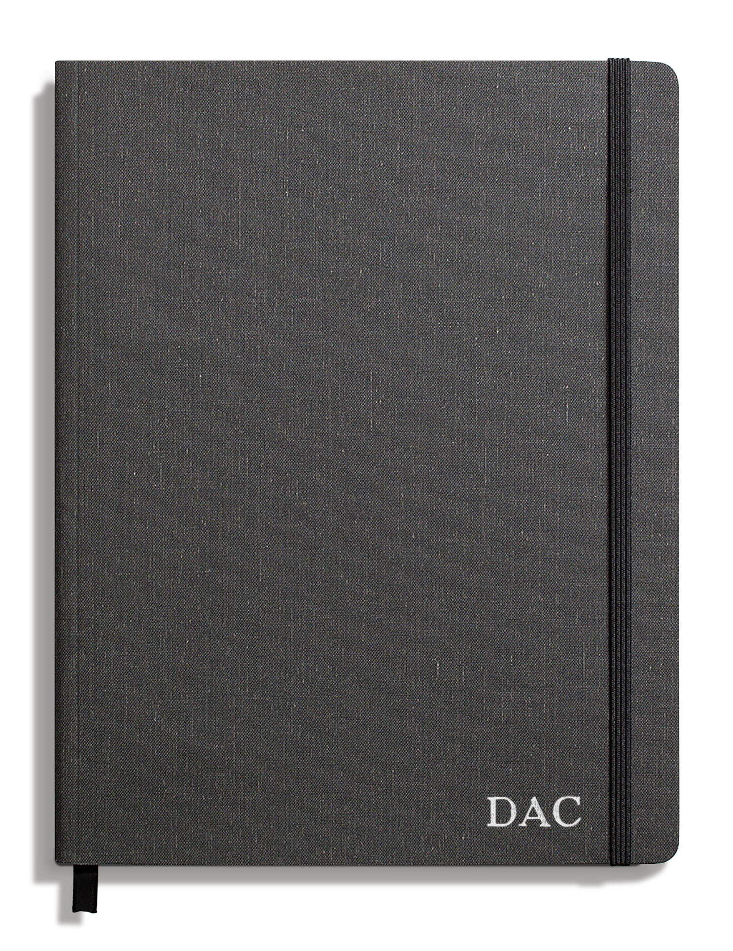The Shinola Large Soft Ruled Journal in Charcoal features a smyth-sewn binding, a black elastic closure on the right edge, and the initials DAC printed in white on the lower right of its dark gray fabric cover.