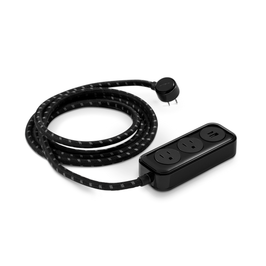 The Shinola 2 Port Power Supply - Black features a braided extension cord with a right-angle plug, two standard outlets, and a USB port. Its modern, compact design includes a dual port quick charger on a plain white background.