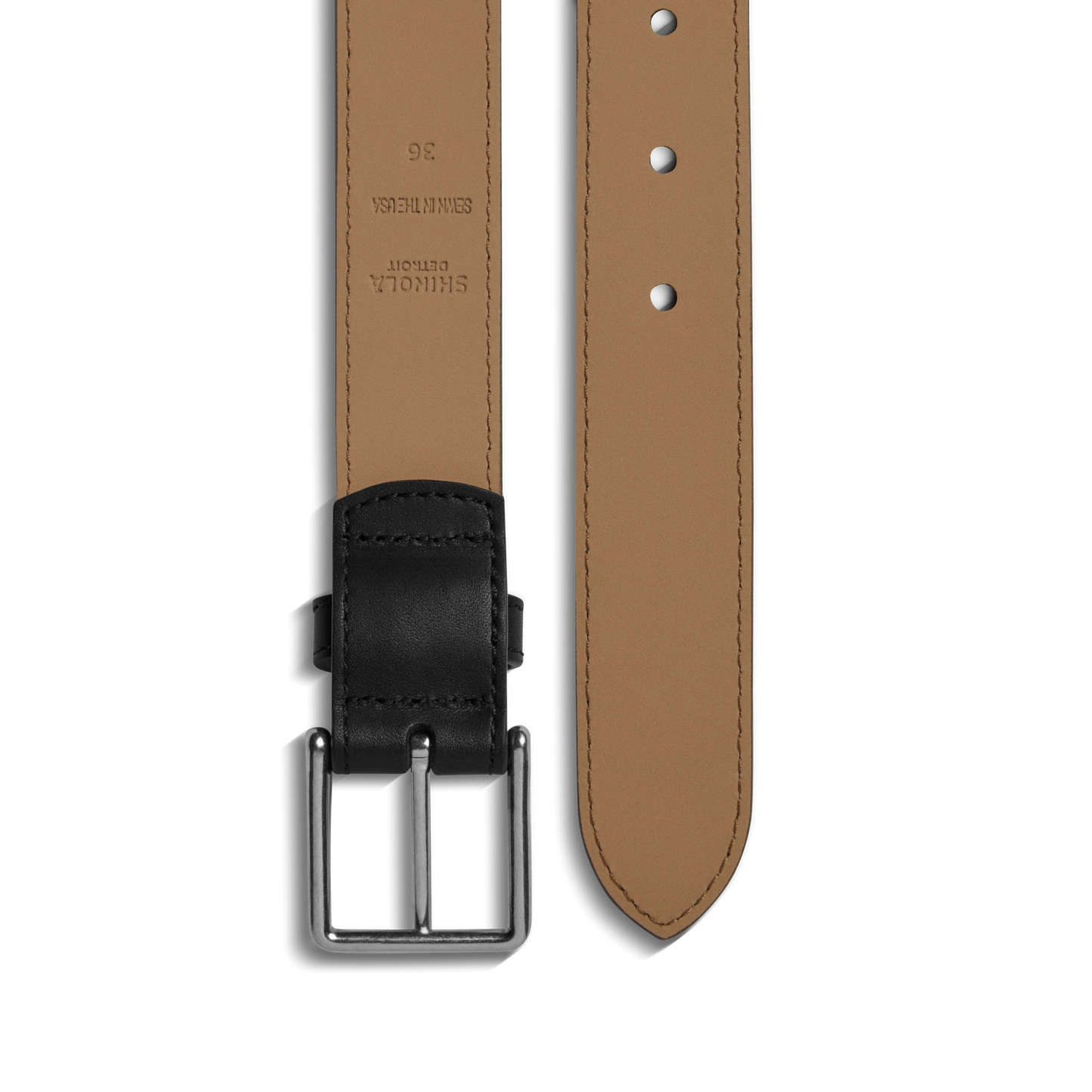 A close-up of the Shinola 1 1/4" Dress Belt in black features premium leather, a matching black buckle, several adjustment holes, and detailed stitching along the edges for a refined finish.
