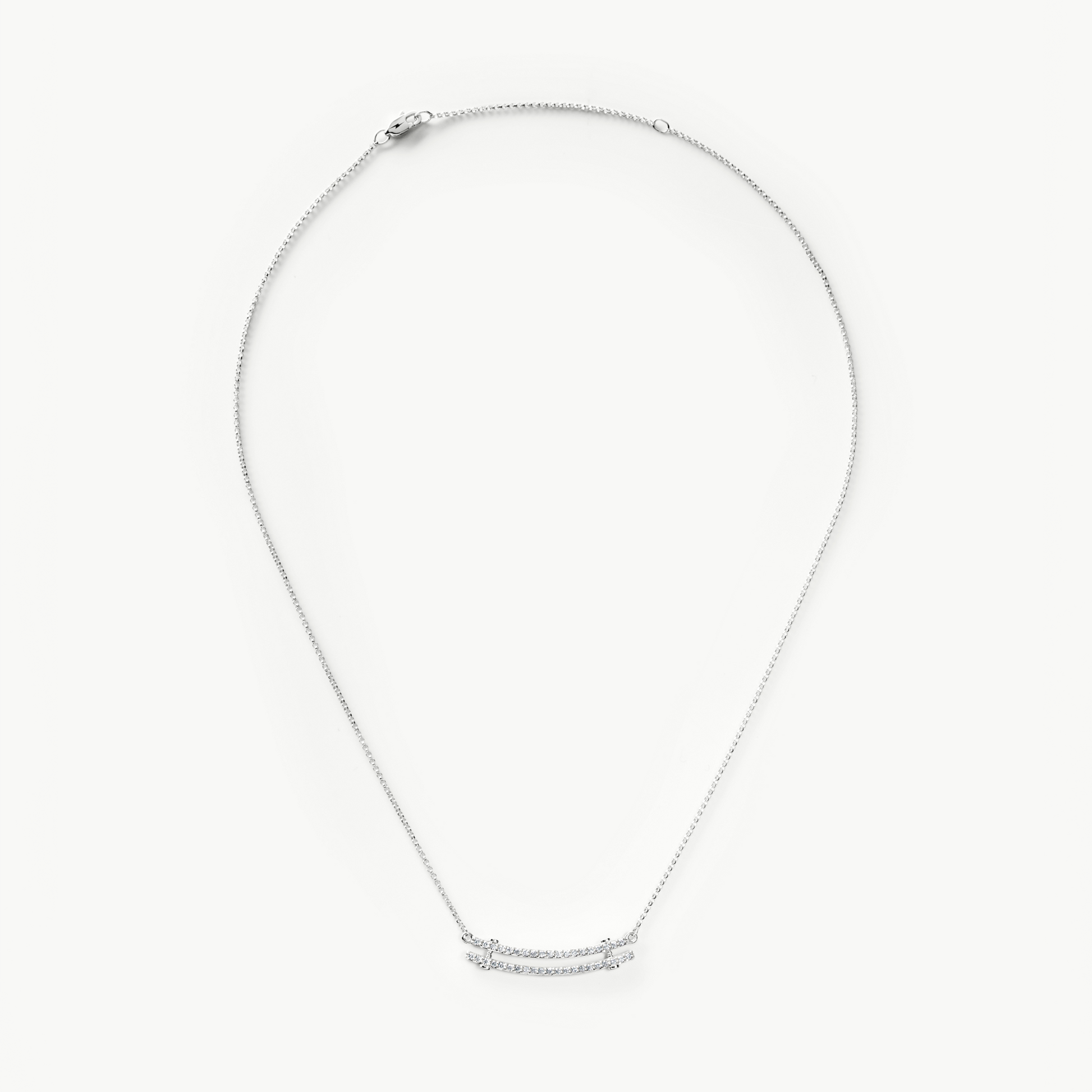 The Shinola Diamond Pave Rivet Double Row Necklace in 14k white gold features a horizontal, curved bar adorned with sparkling stones at the center, from the Rivet Collection, shown against a white background.
