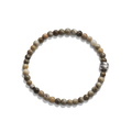 The Shinola 4mm Beaded Petoskey Bracelet features small, round Petoskey stones in brown, beige, and gray with a single engraved sterling silver accent bead.