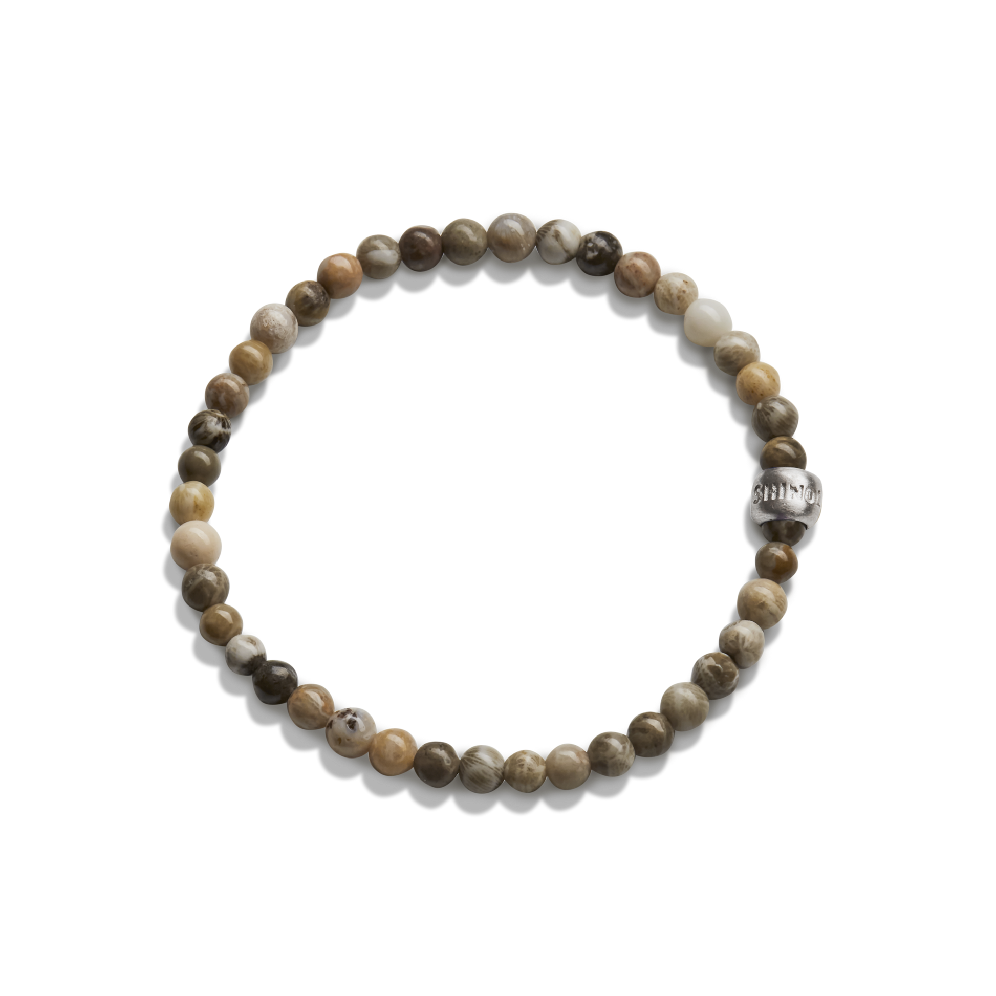 The Shinola 4mm Beaded Petoskey Bracelet features small, round Petoskey stones in brown, beige, and gray with a single engraved sterling silver accent bead.