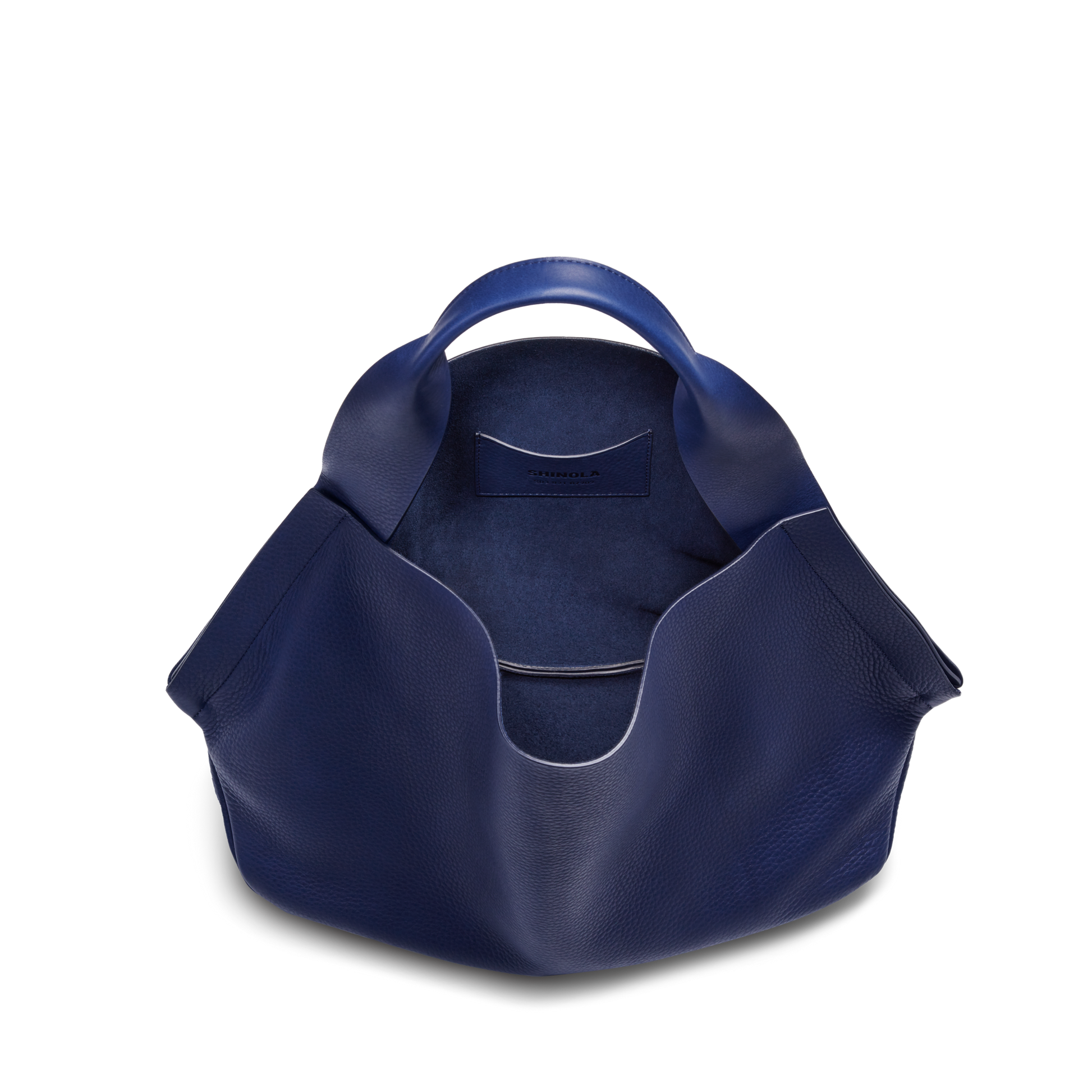 A top view of the Shinola Runwell Shoulder Bag - Lake shows its deep blue leather, rounded handles, spacious interior with smooth lining, and an inside leather card pocket.