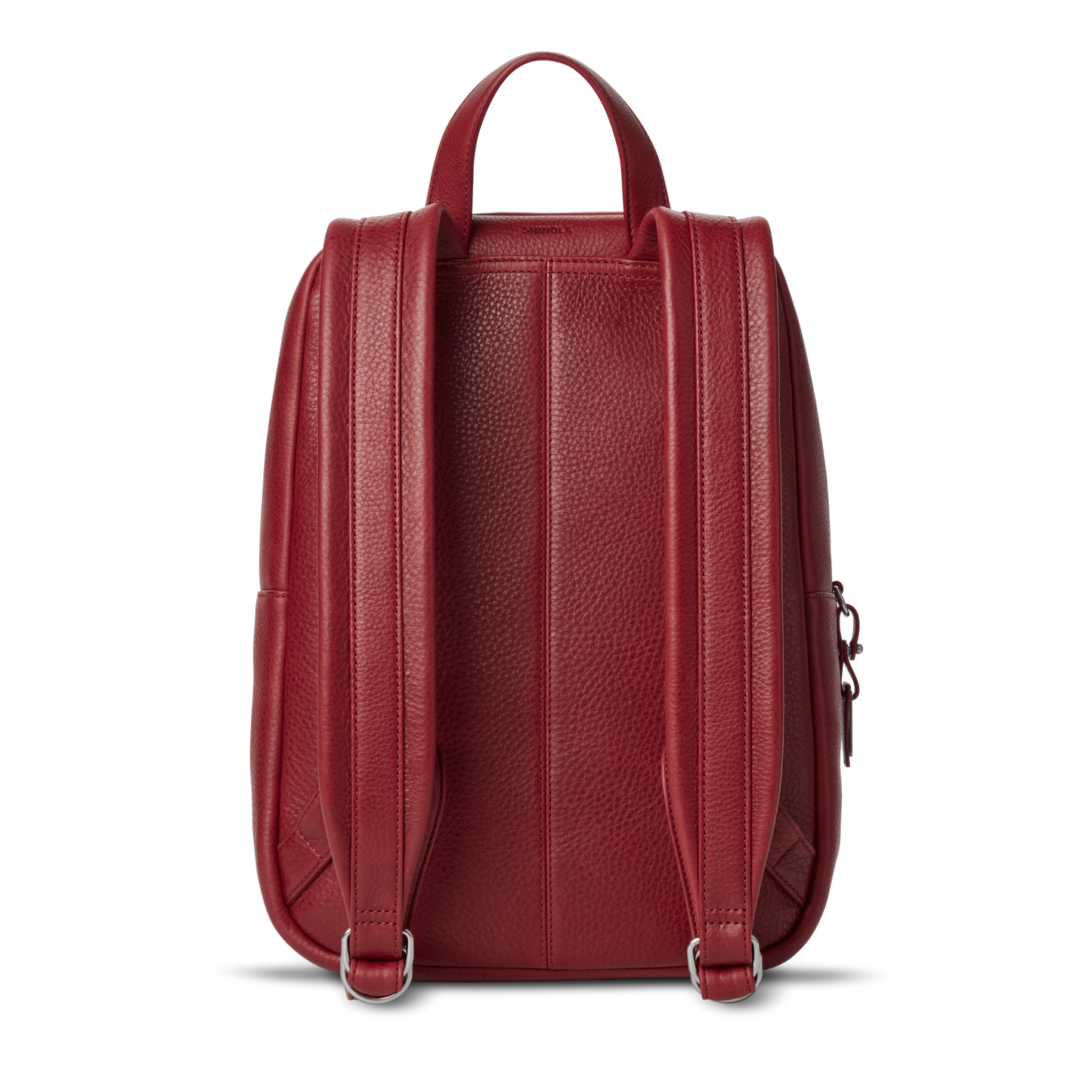 The Shinola Small Runwell Backpack - Ruby, crafted from Natural Grain Leather, features adjustable straps and a top handle for a sleek, stylish, and compact look.
