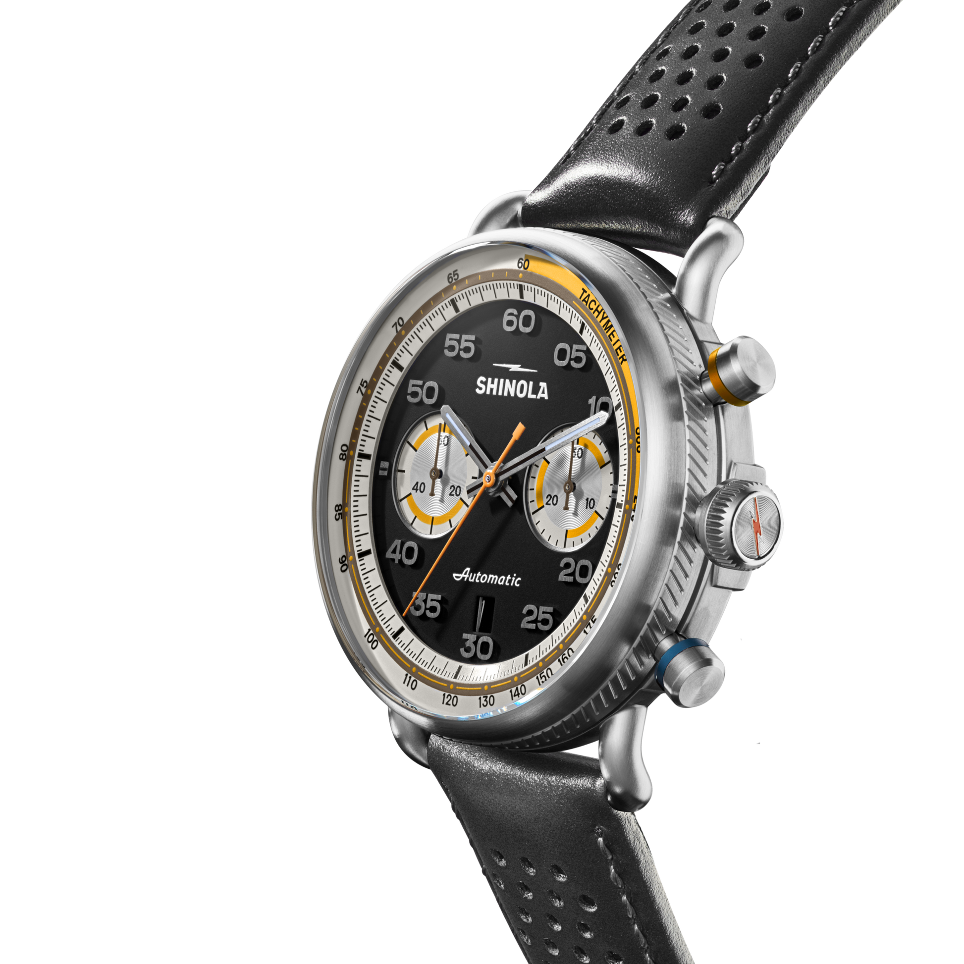 The Shinola Canfield Speedway Open Road Automatic Chronograph Watch features a black dial with three subdials, yellow and white accents, tachymeter scale, and a black perforated leather strap, shown angled on a white background.
