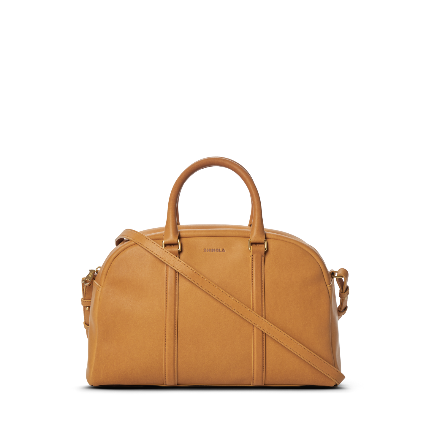 The Shinola Runwell Satchel - Honey is a premium natural leather handbag with two handles, a detachable shoulder strap, subtle vertical stitching, and a small embossed logo on its structured, rounded front.