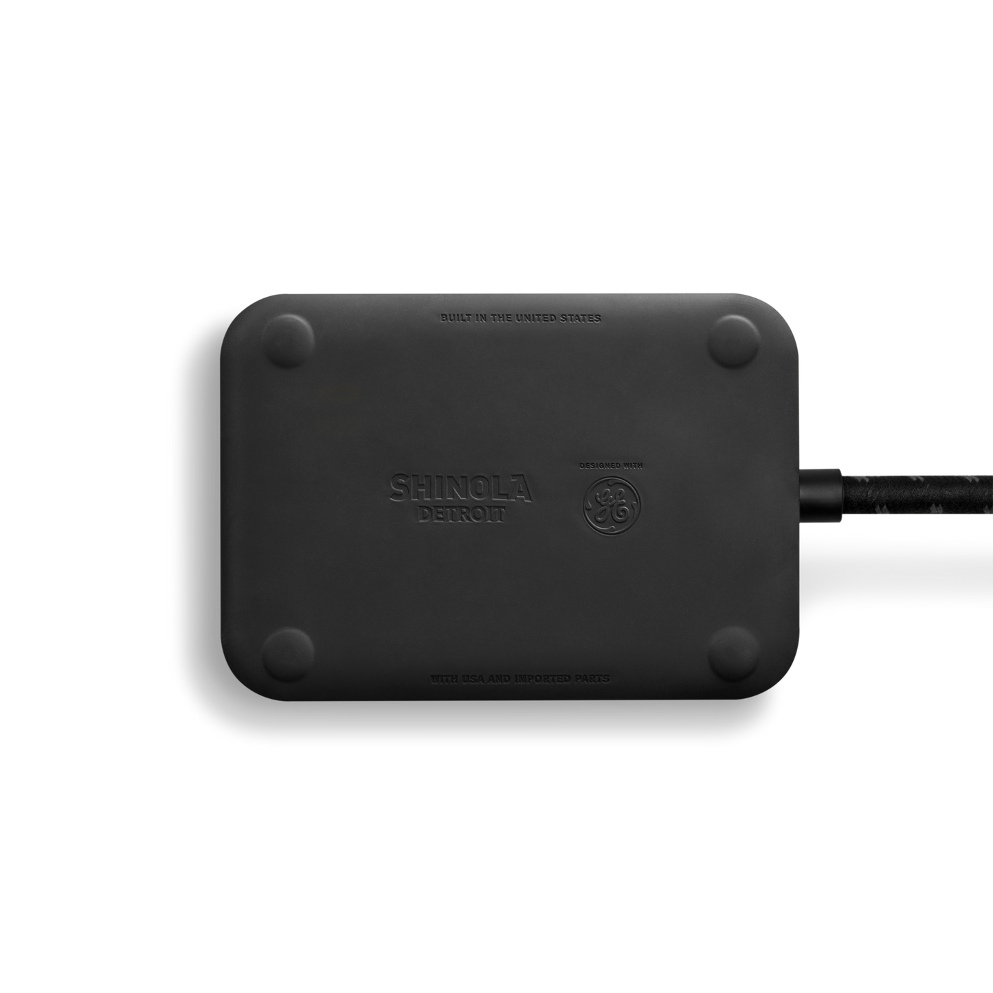 The Shinola 5 Port Power Supply - Black is a rectangular device with rounded corners, featuring a custom braided extension cord on the right side, bearing the Shinola logo, set against a white background.