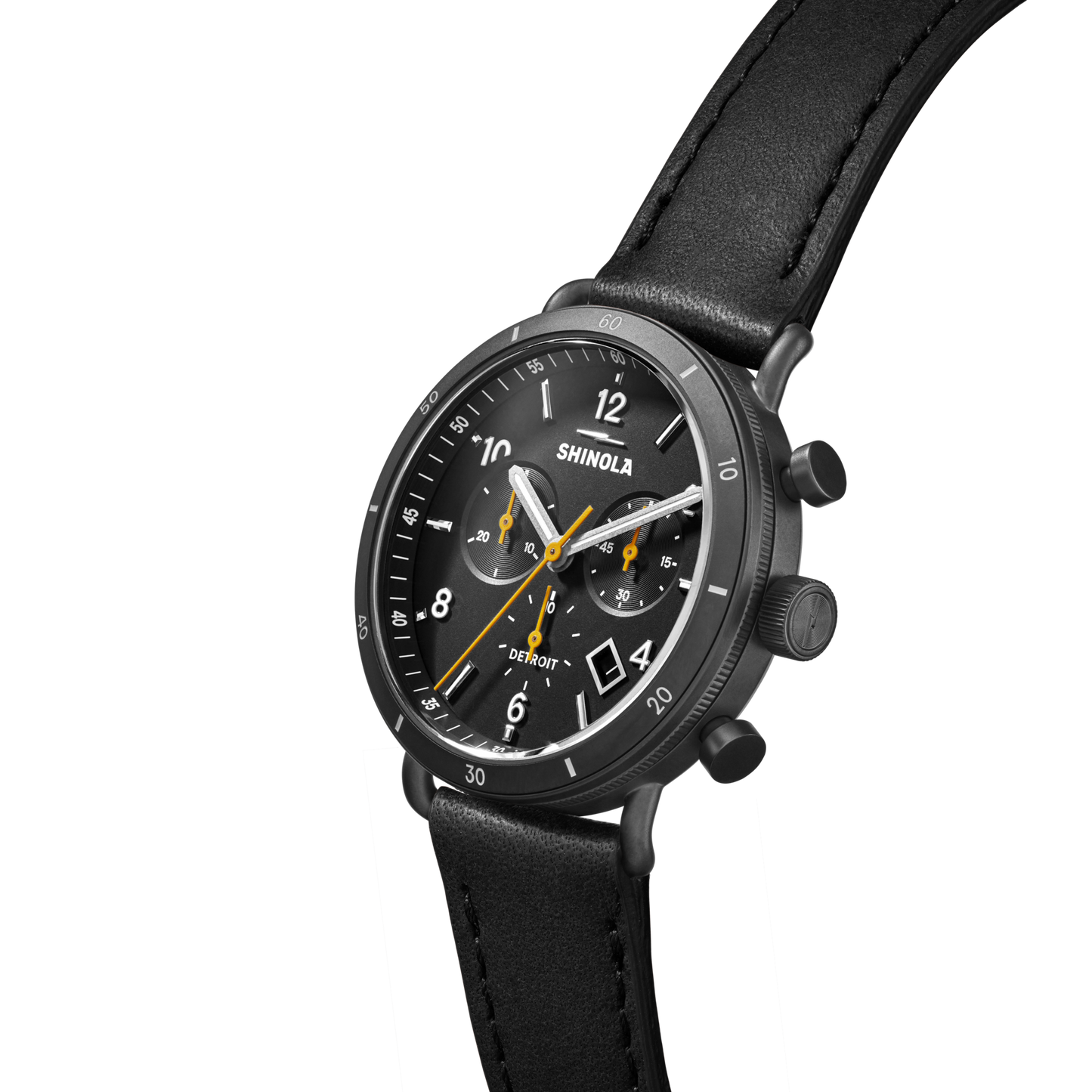 The Shinola Canfield Sport Chronograph Watch, featuring a black leather strap, gunmetal stainless steel case, black dial with white numerals and yellow accents, is shown against a light gray background.