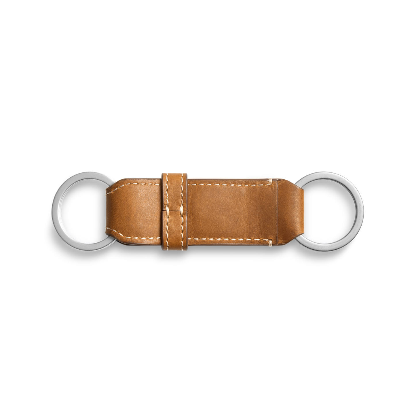 The Shinola Leather Valet Key Fob in tan features white stitching and two silver rings at each end, shown on a plain white background.