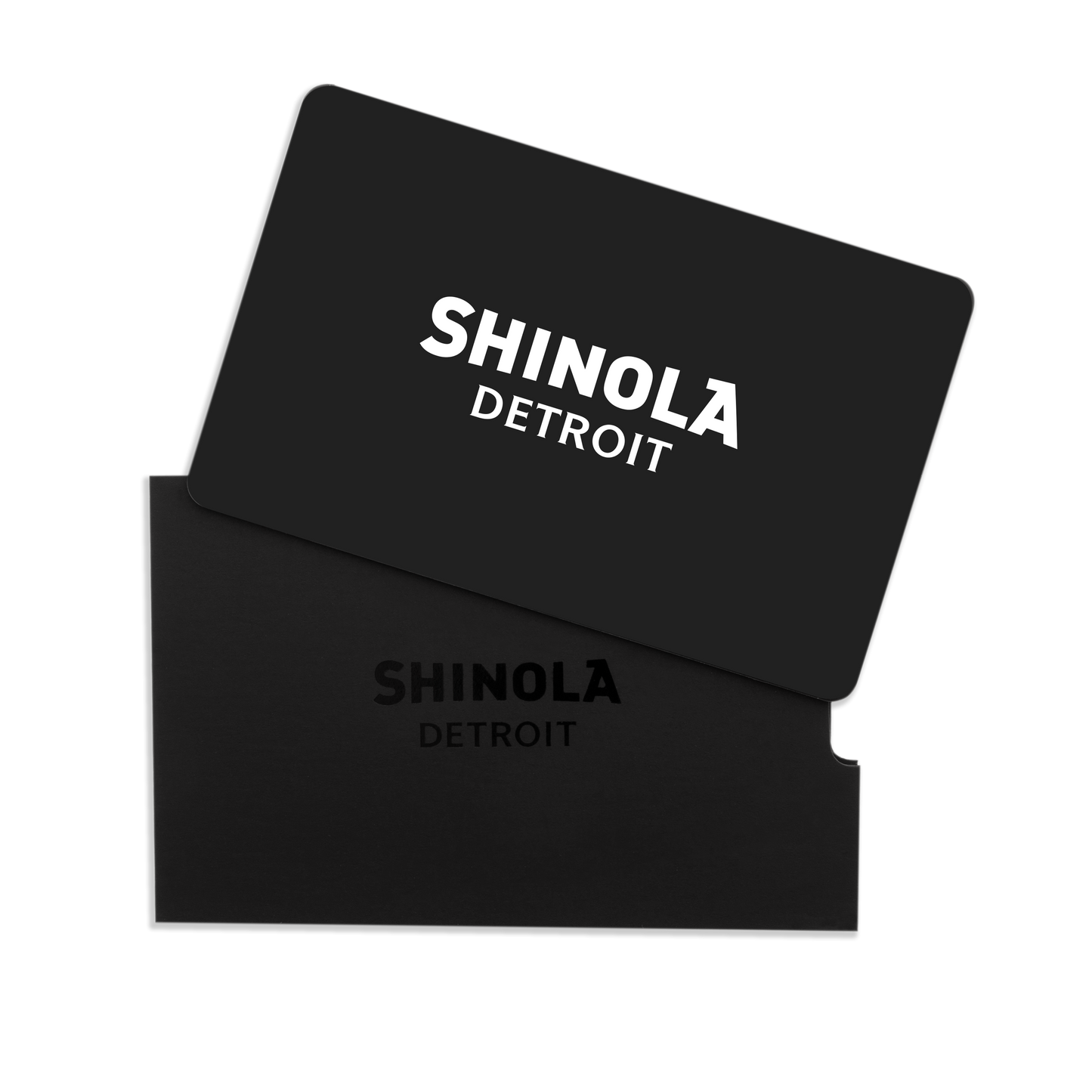 A Physical Gift Card with SHINOLA DETROIT in white lettering is partially inserted into a matching black sleeve embossed with the brand name, both displayed on a white background.