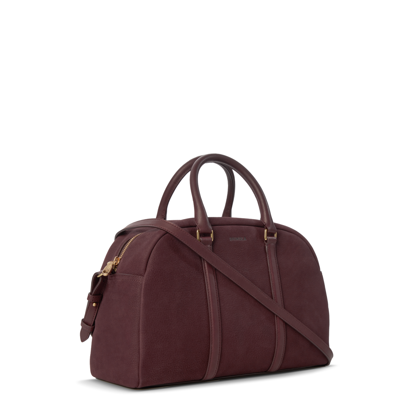 The Shinola Runwell Satchel - Merlot is a structured women's crossbody in dark burgundy Nubuck leather with gold hardware, two handles, and a detachable strap, shown on a plain white background.