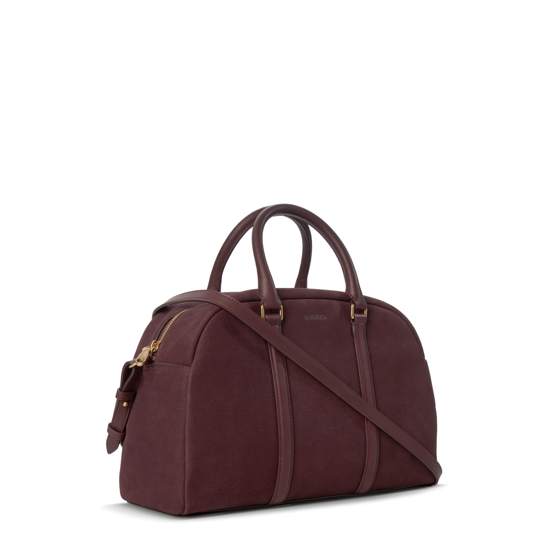 The Shinola Runwell Satchel - Merlot is a structured women's crossbody in dark burgundy Nubuck leather with gold hardware, two handles, and a detachable strap, shown on a plain white background.