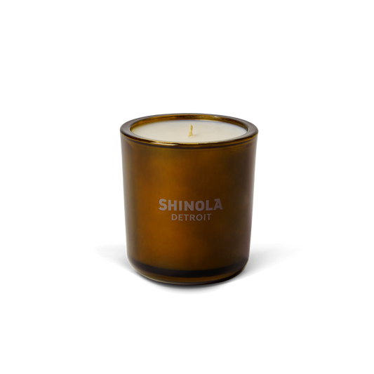 The Shinola Hotel 8oz Scented Candle features premium coconut soy wax in a brown recycled glass vessel with a single wick and "Shinola Detroit" label, displayed on a plain white background.
