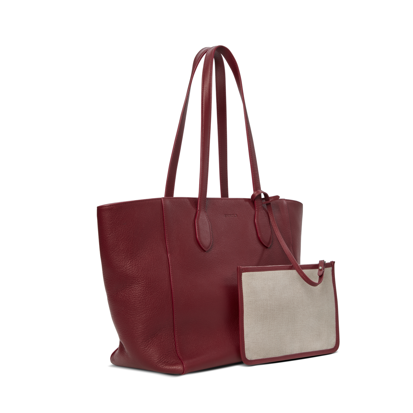 The Shinola Runabout Tote Bag - Ruby, a spacious red pebbled leather tote with double handles, is displayed with a detachable beige zipper pouch trimmed in red, both set against a plain white background.