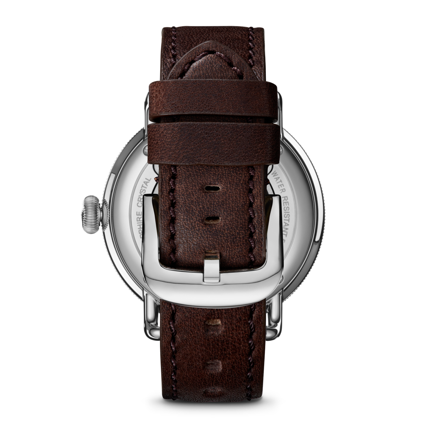 A close-up of the Shinola Canfield Watch - Dark Olive shows its brown leather strap with visible stitching, a silver buckle, and a stainless steel case featuring engraved details.