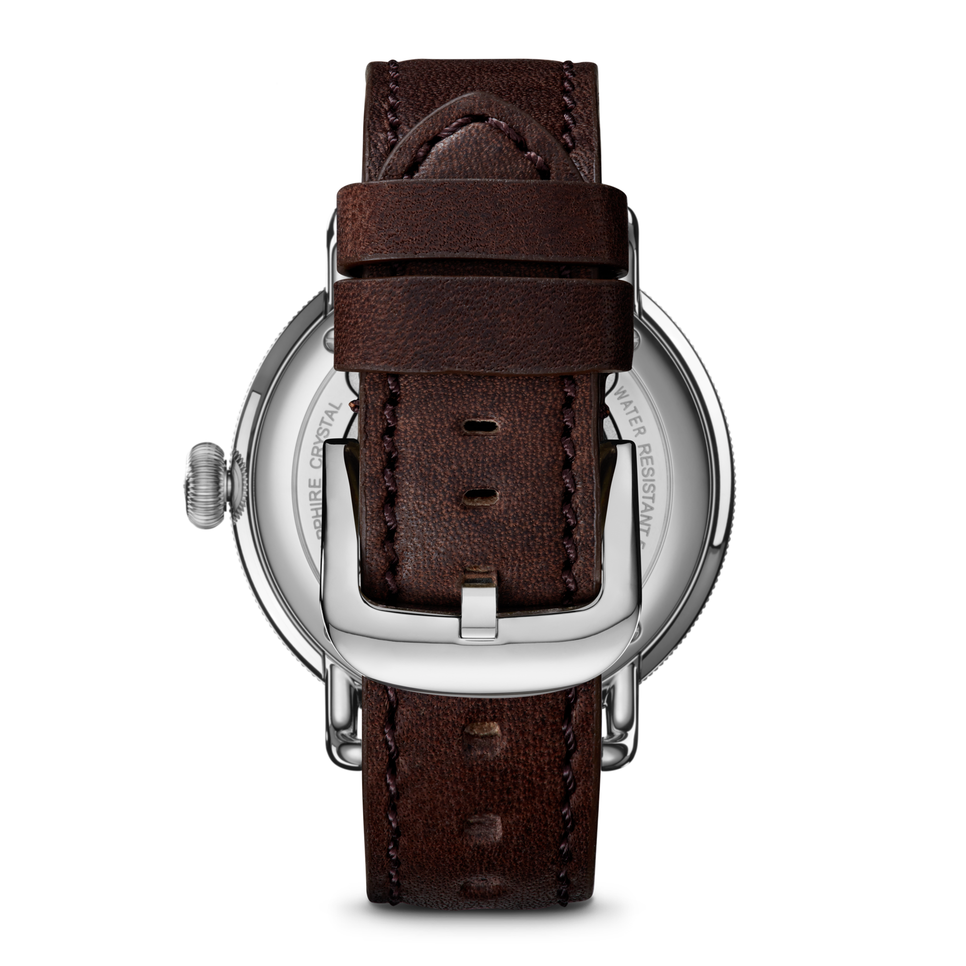 A close-up of the Shinola Canfield Watch - Dark Olive shows its brown leather strap with visible stitching, a silver buckle, and a stainless steel case featuring engraved details.